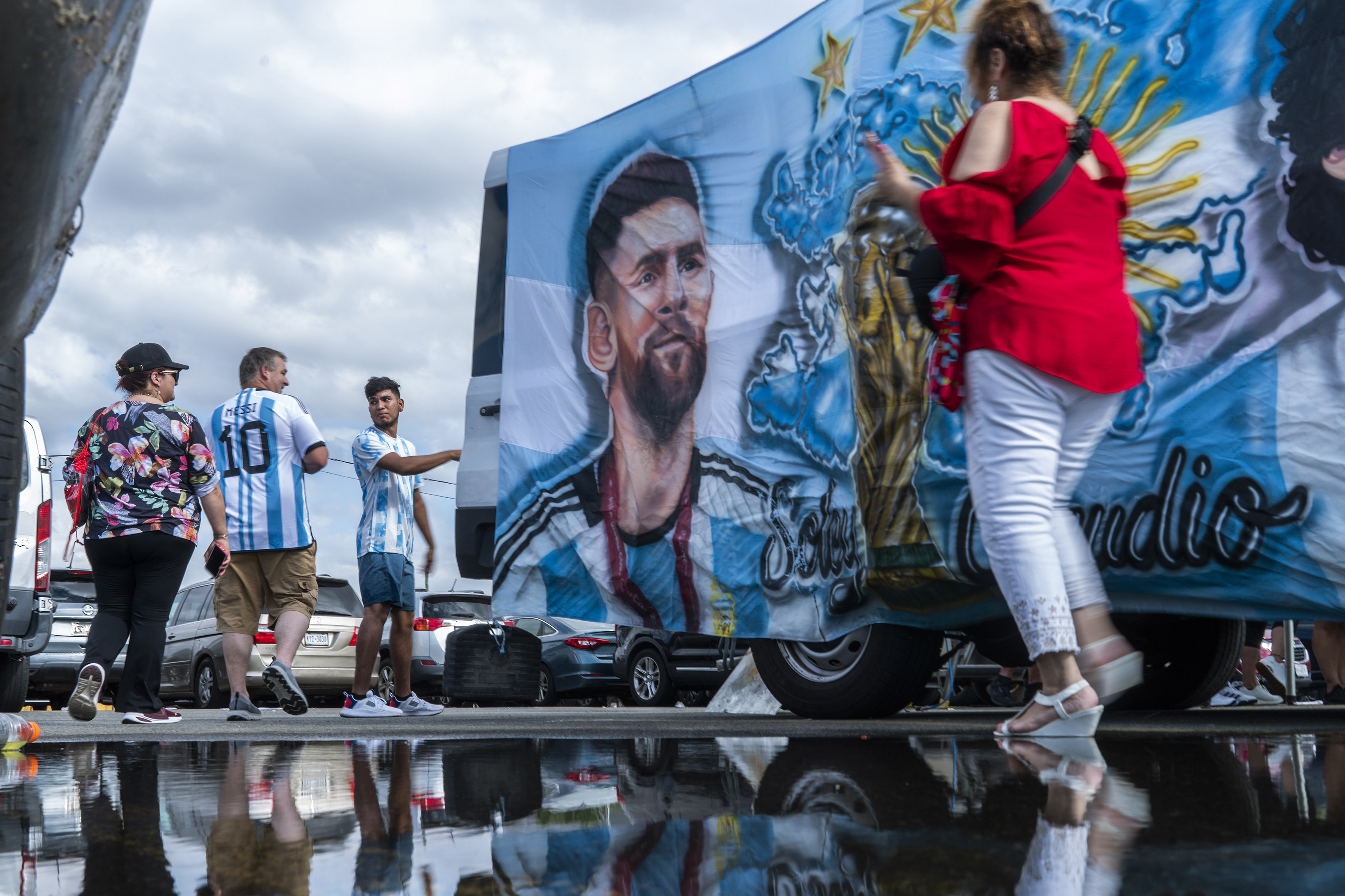 Fans walk by an image of Inter Miami's Lionel Messi as they arrive to attend an MLS soccer match against the New York Red Bulls at Red Bull Arena, Saturday, Aug. 26, 2023, in Harrison, N.J. 