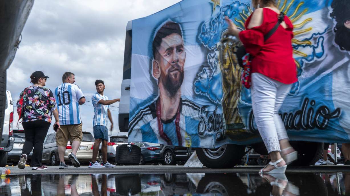 Fans walk by an image of Inter Miami's Lionel Messi as they arrive to attend an MLS soccer match against the New York Red Bulls at Red Bull Arena, Saturday, Aug. 26, 2023, in Harrison, N.J.