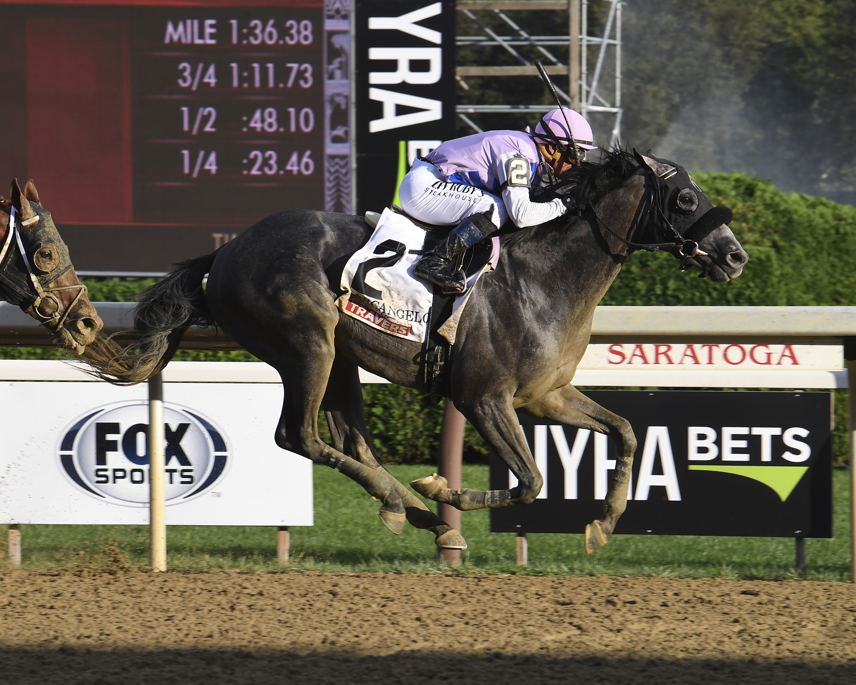 In this photo provided by NYRA, Arcangelo, with Javier Castellano aboard, wins the Travers Stakes horse race at Saratoga Race Course in Saratoga Springs, N.Y., Saturday, Aug. 26, 2023. 