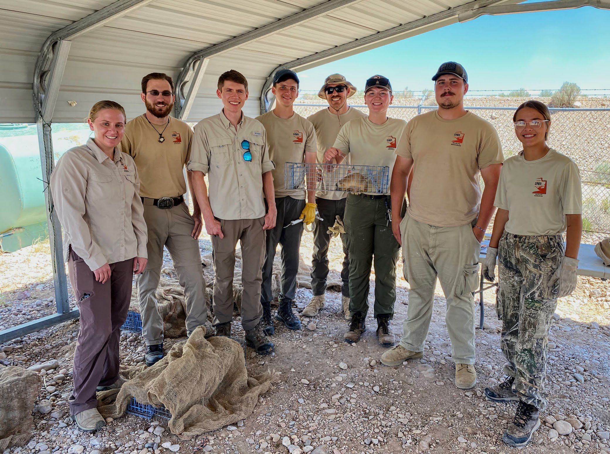 Utah Division of Wildlife Resources biologists and technicians pose with a captured prairie dog that will be relocated to new habitat, including, from left, Barbara Sugarman, Jake Durbin, Patrick Anderson, Paul Rindler, Bannon Gallaher, Baylee Moyer, Josh Morris and Eve Mostrom.