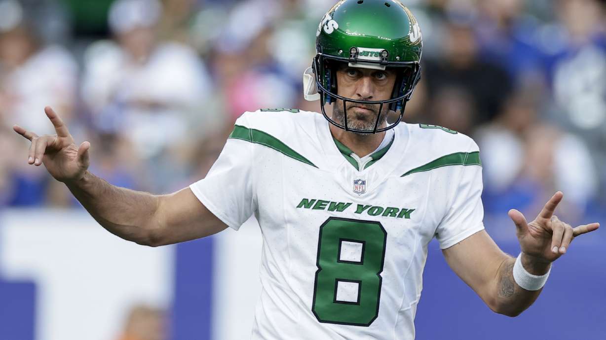 New York Jets quarterback Aaron Rodgers (8) sets up for a play during the first half of an NFL preseason football game against the New York Giants, Saturday, Aug. 26, 2023, in East Rutherford, N.J.