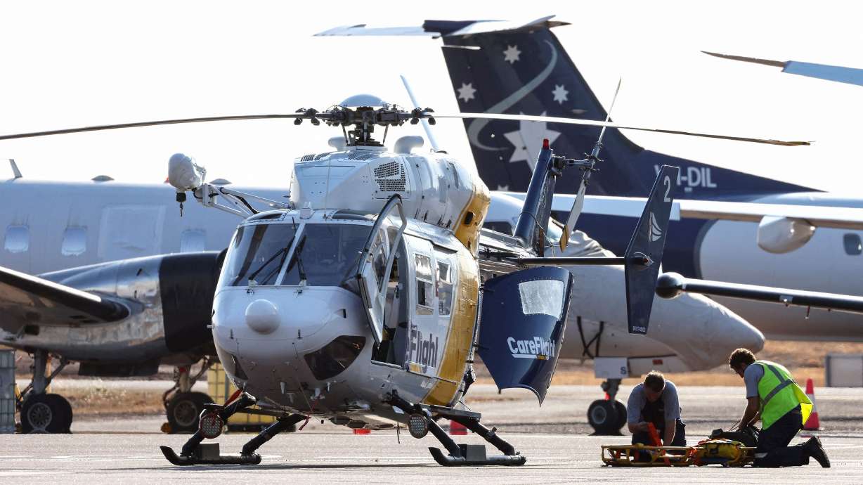 A Care Flight helicopter is seen on the tarmac of the Darwin International Airport in Darwin on Sunday. Three U.S. Marines died on Sunday after an Osprey aircraft crashed on a remote tropical island north of Australia.