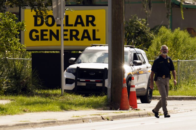 Law enforcement officials continue their investigation at a Dollar General Store that was the scene of a mass shooting, Sunday in Jacksonville, Fla.