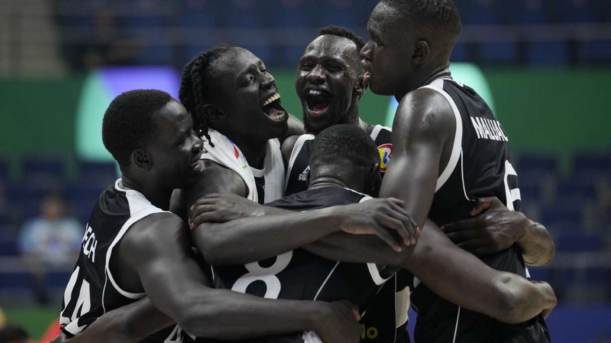 South Sudan players celebrate after winning against China during their Basketball World Cup group B match at the Araneta Coliseum in Manila, Philippines Monday, Aug. 28, 2023.