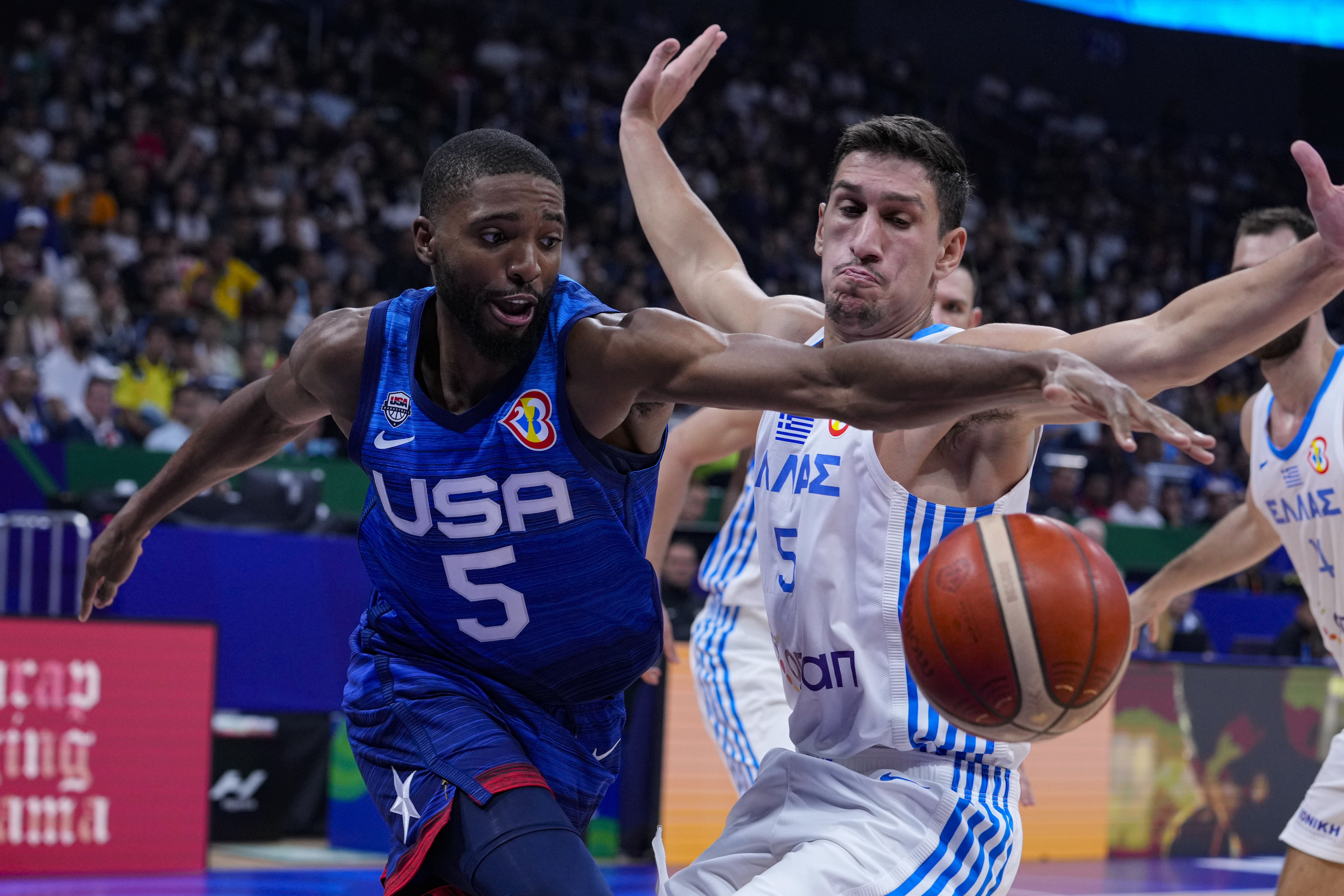 U.S. forward Mikal Bridges (5) recovers the ball in front of Greece guard Giannoulis Larentzakis (5) during the first half of a Basketball World Cup group C match in Manila, Philippines Monday, Aug. 28, 2023.