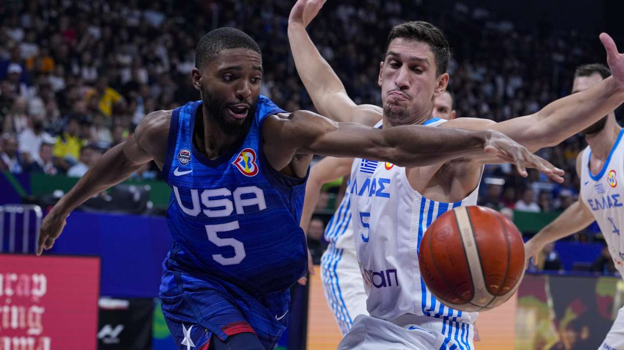 U.S. forward Mikal Bridges (5) recovers the ball in front of Greece guard Giannoulis Larentzakis (5) during the first half of a Basketball World Cup group C match in Manila, Philippines Monday, Aug. 28, 2023.