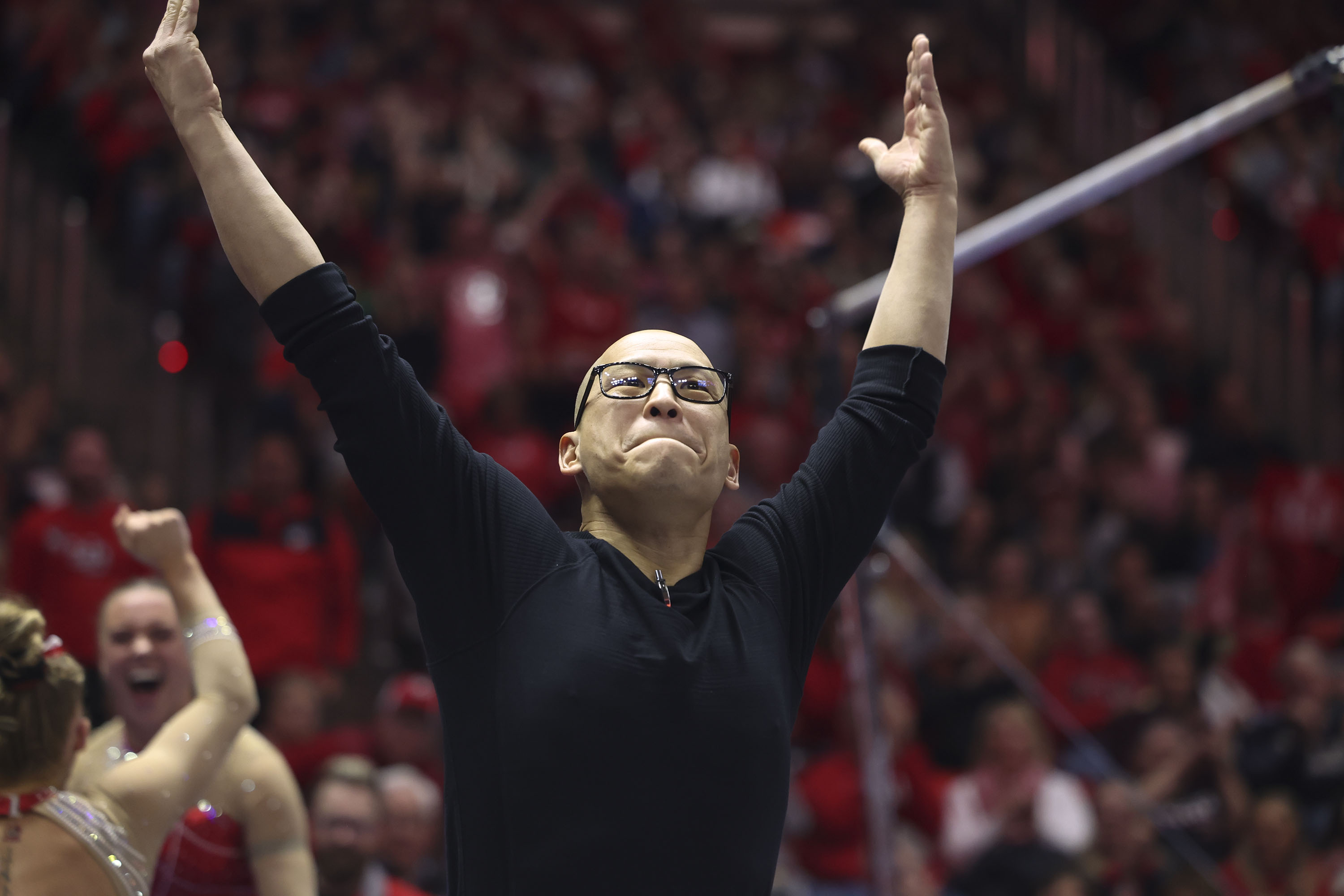 Utah’s gymnastics coach Tom Farden gets the crowd excited at the Huntsman Center in Salt Lake City on Feb. 3. Former gymnasts and parents allege Farden verbally and emotionally abused athletes; others defend the coach.