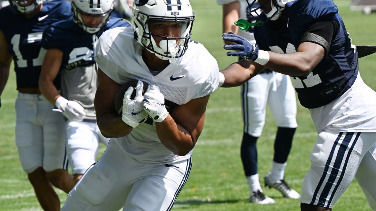 BYU freshman running back LJ Martin looks for a pathway during practice in Provo on Tuesday, Aug. 8, 2023.