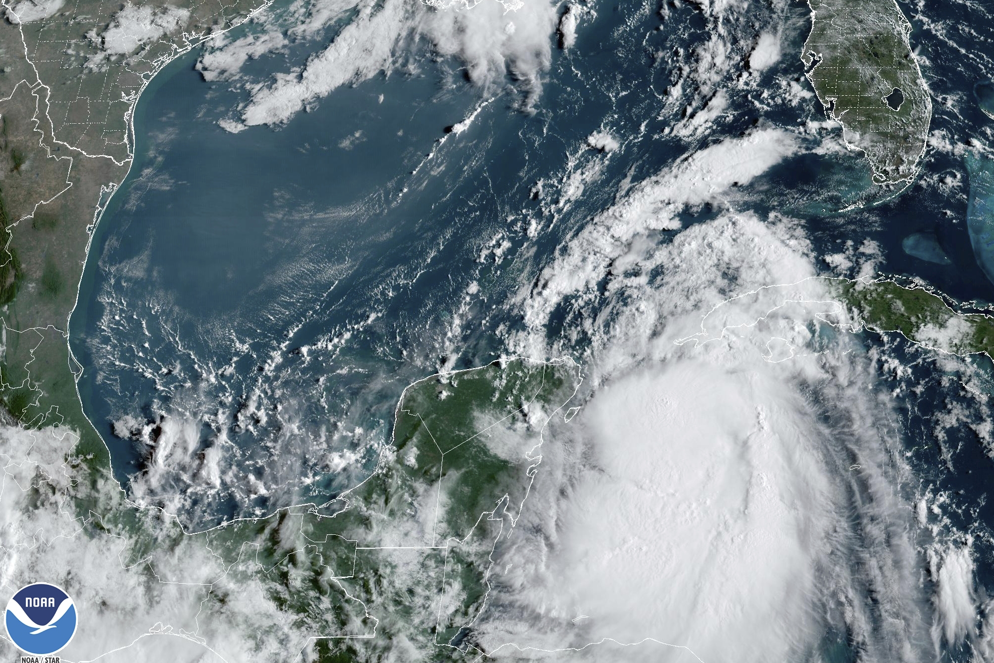 In this Monday, Aug. 28, 2023, 9:41 am ET satellite image provided by the National Oceanic and Atmospheric Administration, Tropical Storm Idalia moves between Mexico's Yucatan peninsula, left, and Cuba, right. Idalia intensified early Monday and was expected to become a major hurricane before it reaches Florida's Gulf coast, according to the National Hurricane Center. 