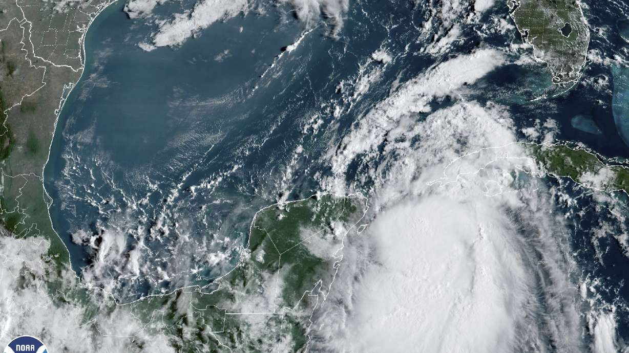 In this Monday, Aug. 28, 2023, 9:41 am ET satellite image provided by the National Oceanic and Atmospheric Administration, Tropical Storm Idalia moves between Mexico's Yucatan peninsula, left, and Cuba, right. Idalia intensified early Monday and was expected to become a major hurricane before it reaches Florida's Gulf coast, according to the National Hurricane Center.