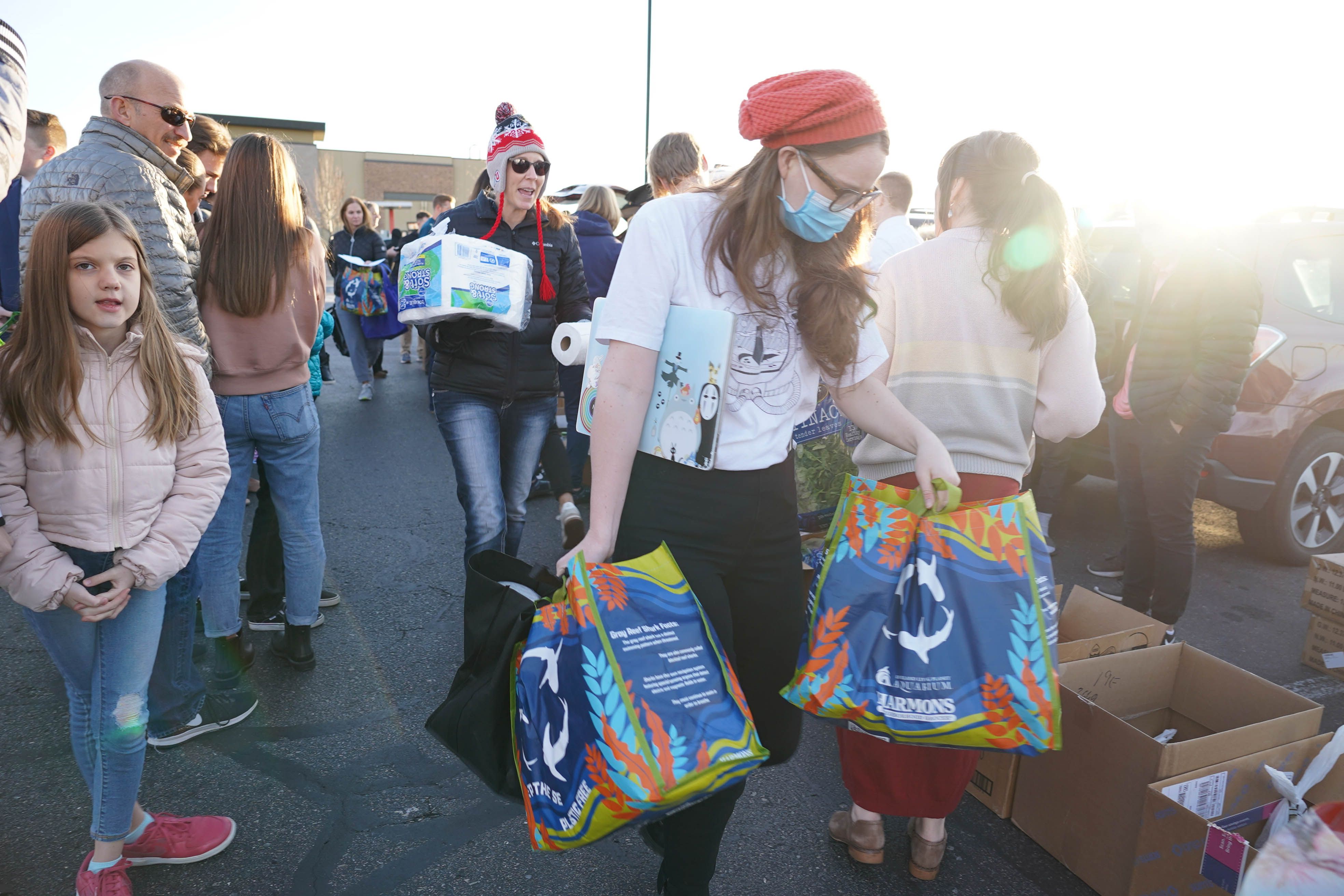 Volunteers load boxes to deliver to 25 newly arrived Afghan families on Dec. 5, 2021.