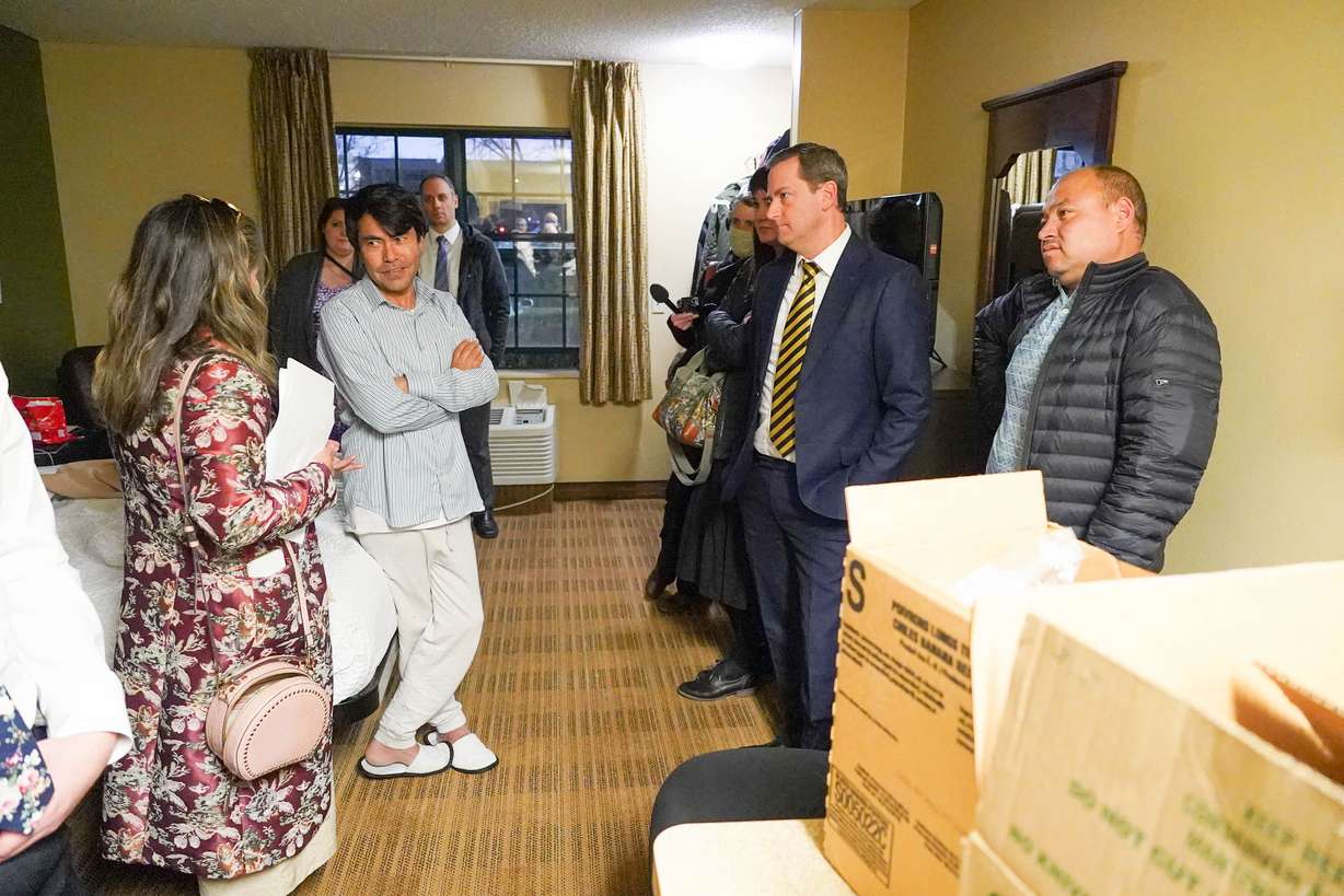 Nazifa translates for an Afghan man who is staying in a hotel with his 21-year-old son. He thanks the volunteers for the food delivery, but says his biggest concern is for the safety of his wife and four younger children still in Afghanistan.