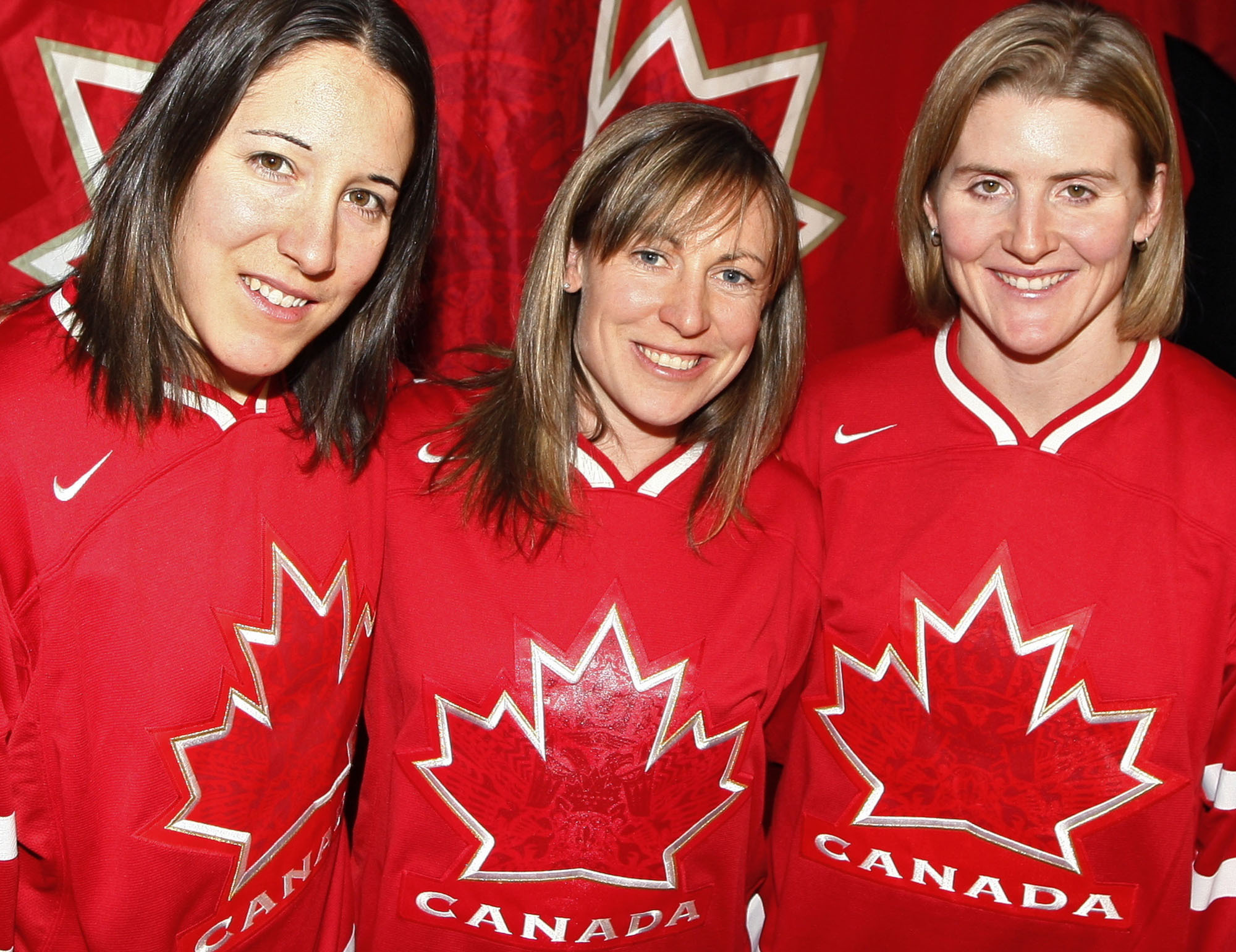 FILE - Canadian women's hockey team co-captain Jayna Hefford, center, is flanked by co-captain Carolina Ouellette, left, and captain Hayley Wickenheiser, right, in Calgary, Alberta, Dec. 21, 2009. The newly established Professional Women’s Hockey League has scheduled a news conference for Tuesday, Aug. 29, 2023, to make its long-awaited announcement on where its six franchises will be based. Hefford is slated to become senior vice president of hockey operations. 