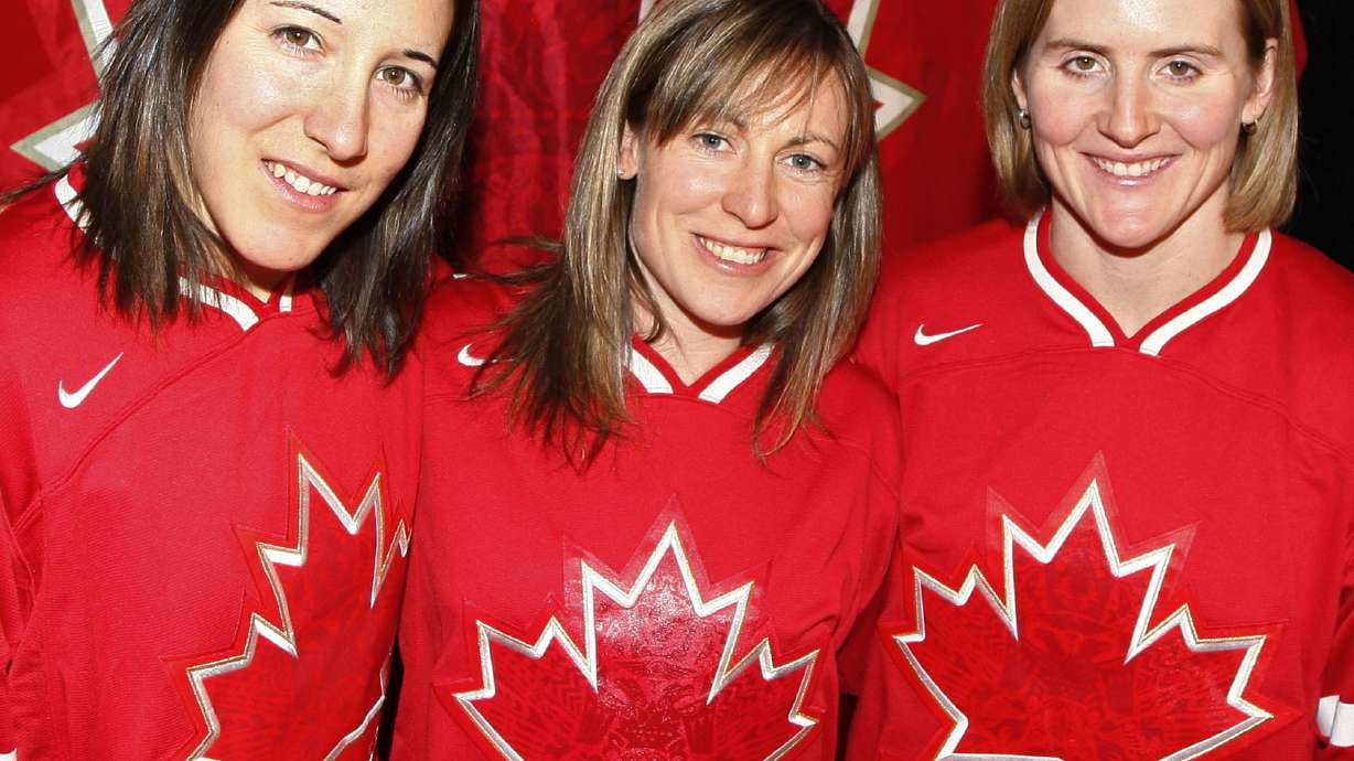 FILE - Canadian women's hockey team co-captain Jayna Hefford, center, is flanked by co-captain Carolina Ouellette, left, and captain Hayley Wickenheiser, right, in Calgary, Alberta, Dec. 21, 2009. The newly established Professional Women’s Hockey League has scheduled a news conference for Tuesday, Aug. 29, 2023, to make its long-awaited announcement on where its six franchises will be based. Hefford is slated to become senior vice president of hockey operations.