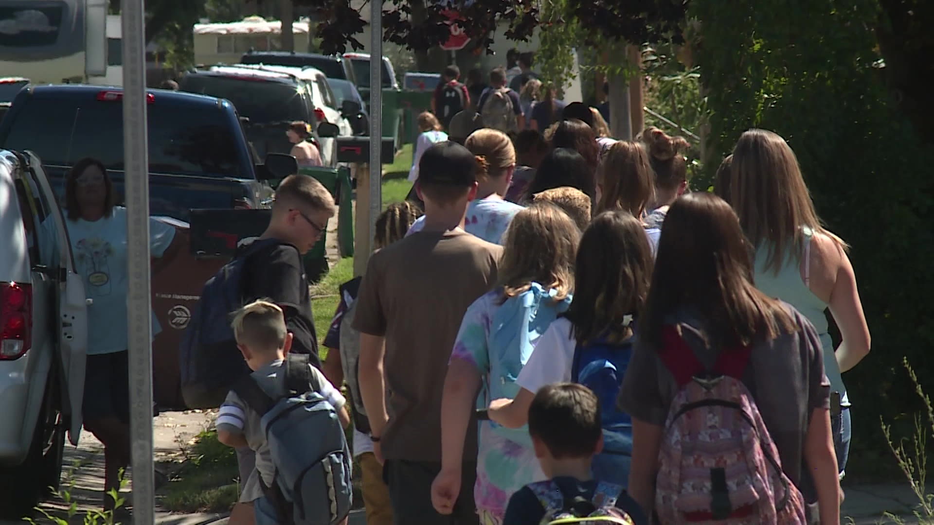On Monday, parents and children in Roy navigate past construction as part of their walk to one of the nearby schools.