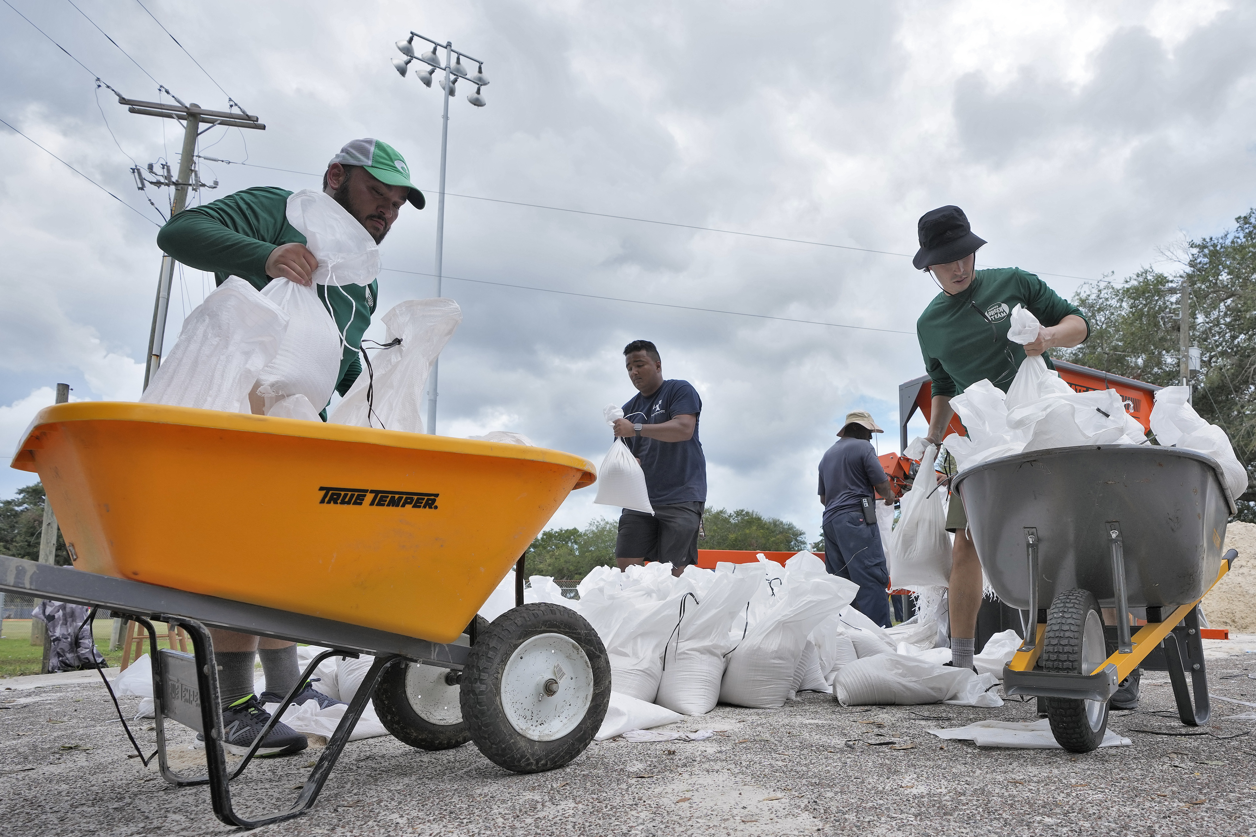 Members of the Tampa, Fla., Parks and Recreation Dept., help residents with sandbags Monday in Tampa, Fla. Residents along Florida's gulf coast are making preparations for the effects of Tropical Storm Idalia.