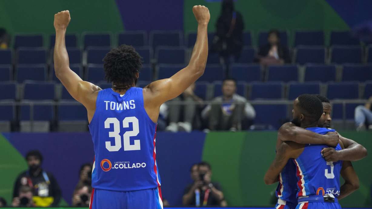 Dominican Republic forward Karl-Anthony Towns (32) and teammates celebrate after winning against Angola during their Basketball World Cup group A match at the Araneta Coliseum, Manila, Philippines on Tuesday, Aug. 29, 2023.
