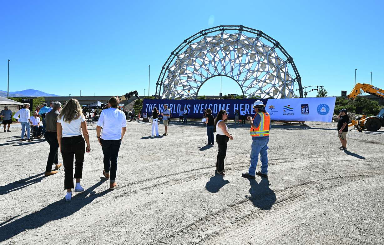 Guests walk around the Hoberman Arch from the 2002 Olympics at the Salt Lake City International Airport on Tuesday.