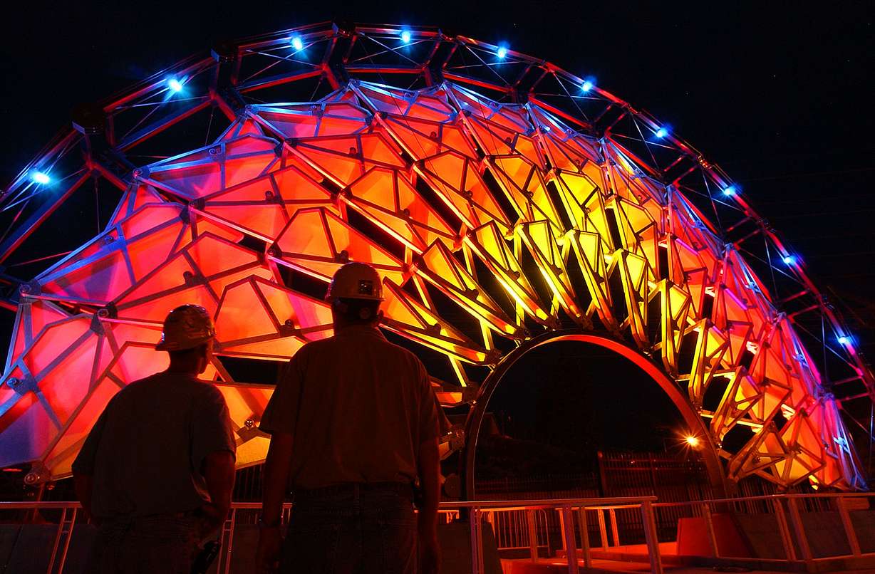 Jacobsen project manager Sean Tuite, right, and Scott Turnbow, project superintendent, test the lighting of the Hoberman Arch at the University of Utah on Aug. 20, 2003, in preparation for an Olympic Legacy Ceremony. The arch ended up outside of Rice-Eccles Stadium until it was moved in 2014.
