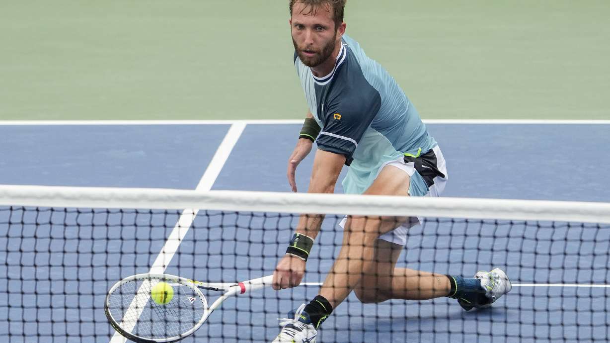 Corentin, Moutet, of France, returns a shot to Andy Murray, of Great Britain, during the first round of the U.S. Open tennis championships, Tuesday, Aug. 29, 2023, in New York.
