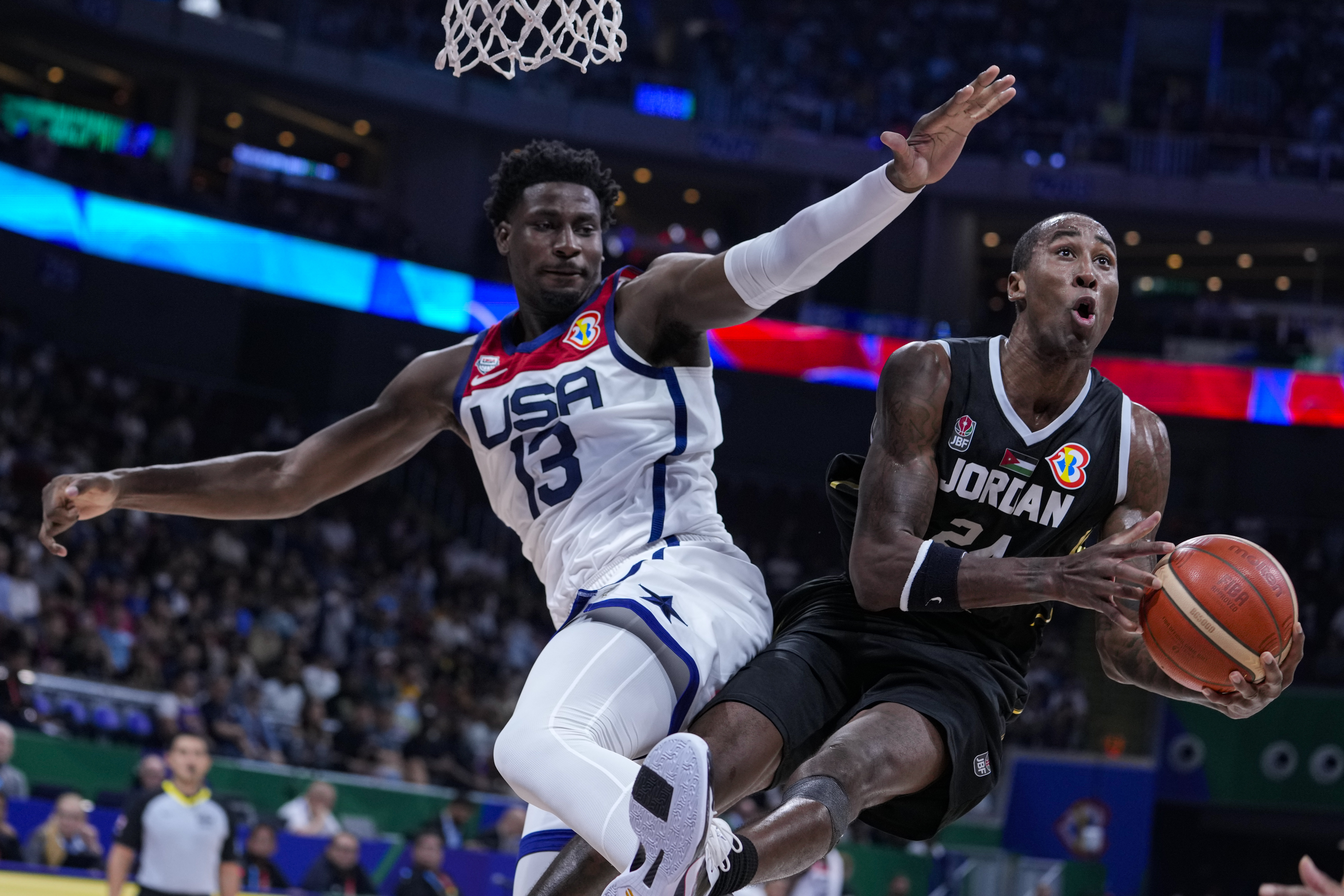 Jordan forward Rondae Hollis Jefferson (24) is fouled by U.S. forward Jaren Jackson Jr. (13) as he shoots during the first half of a Basketball World Cup group C match in Manila, Philippines Wednesday, Aug. 30, 2023. 