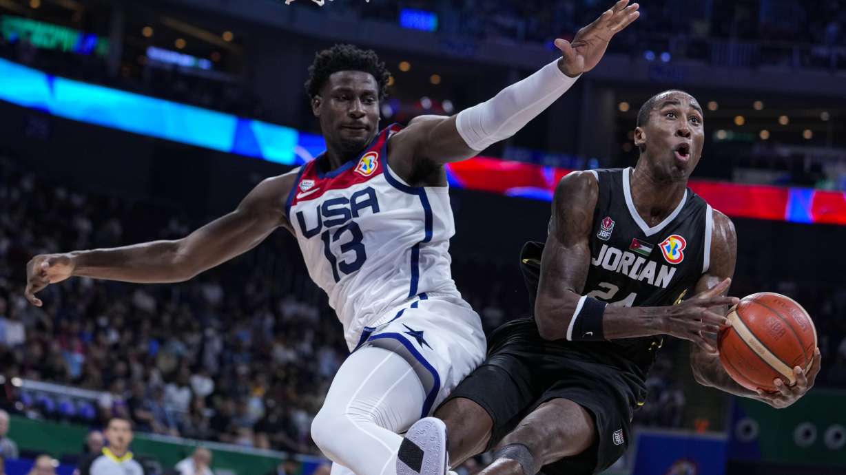 Jordan forward Rondae Hollis Jefferson (24) is fouled by U.S. forward Jaren Jackson Jr. (13) as he shoots during the first half of a Basketball World Cup group C match in Manila, Philippines Wednesday, Aug. 30, 2023.