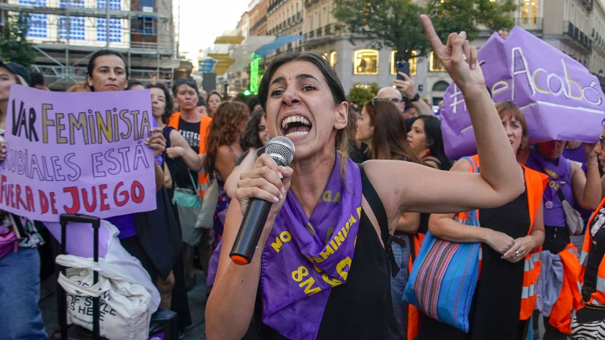 A demonstrator shouts slogans during a protest against the President of Spain's soccer federation Luis Rubiales and to support to support Spain's national women's soccer player Jenni Hermoso in Madrid on Monday, Aug. 28, 2023. Spain faces reckoning over sexism in soccer after federation head kisses player at Women's World Cup. Banner reads in Spanish "it's over" and "Rubiales is out of the game".