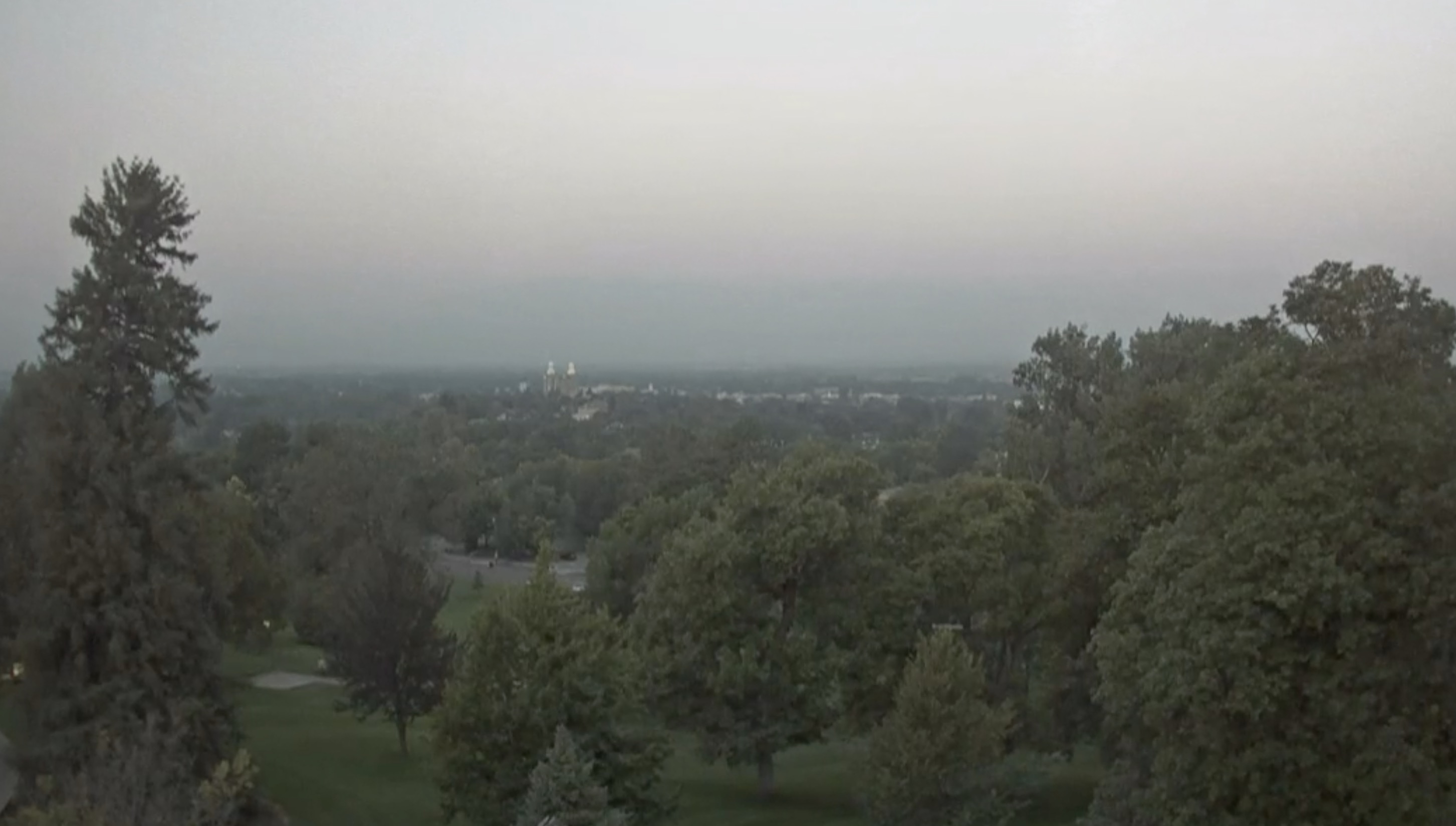 Hazy skies captured by Utah State University's weather camera hinder mountain views Wednesday morning. Smoke from the Pacific Northwest reached Utah on Wednesday, worsening air quality for Utah's northern half.