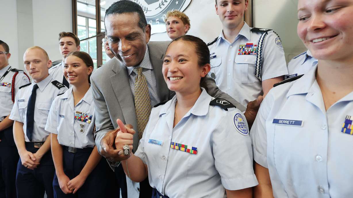 Rep. Burgess Owens, R-Utah, lets University of Utah Air Force Junior ROTC member Andrea Trinidad wear his Super Bowl ring after speaking at the University of Utah Hinckley Institute in Salt Lake City on Wednesday.