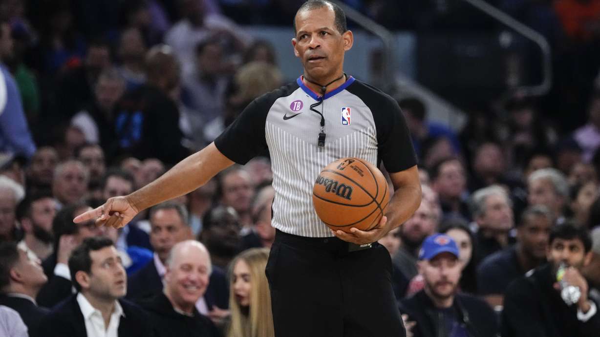 FILE - Referee Eric Lewis gestures during the first half of Game 5 of the NBA basketball Eastern Conference semifinal between the New York Knicks and the Miami Heat, May 10, 2023, in New York. Lewis, one of the NBA's top referees, has retired effective immediately in the wake of a league investigation into whether he used a then-Twitter account to defend himself and other officials from online criticism. The league announced his retirement Wednesday, Aug. 30, 2023.