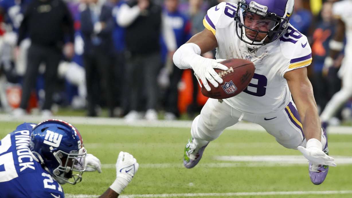 FILE - Minnesota Vikings wide receiver Justin Jefferson (18) catches a 17-yard touchdown pass ahead of New York Giants cornerback Jason Pinnock (27) during the second half of an NFL football game Dec. 24, 2022, in Minneapolis. Jefferson has exceeded high expectations.