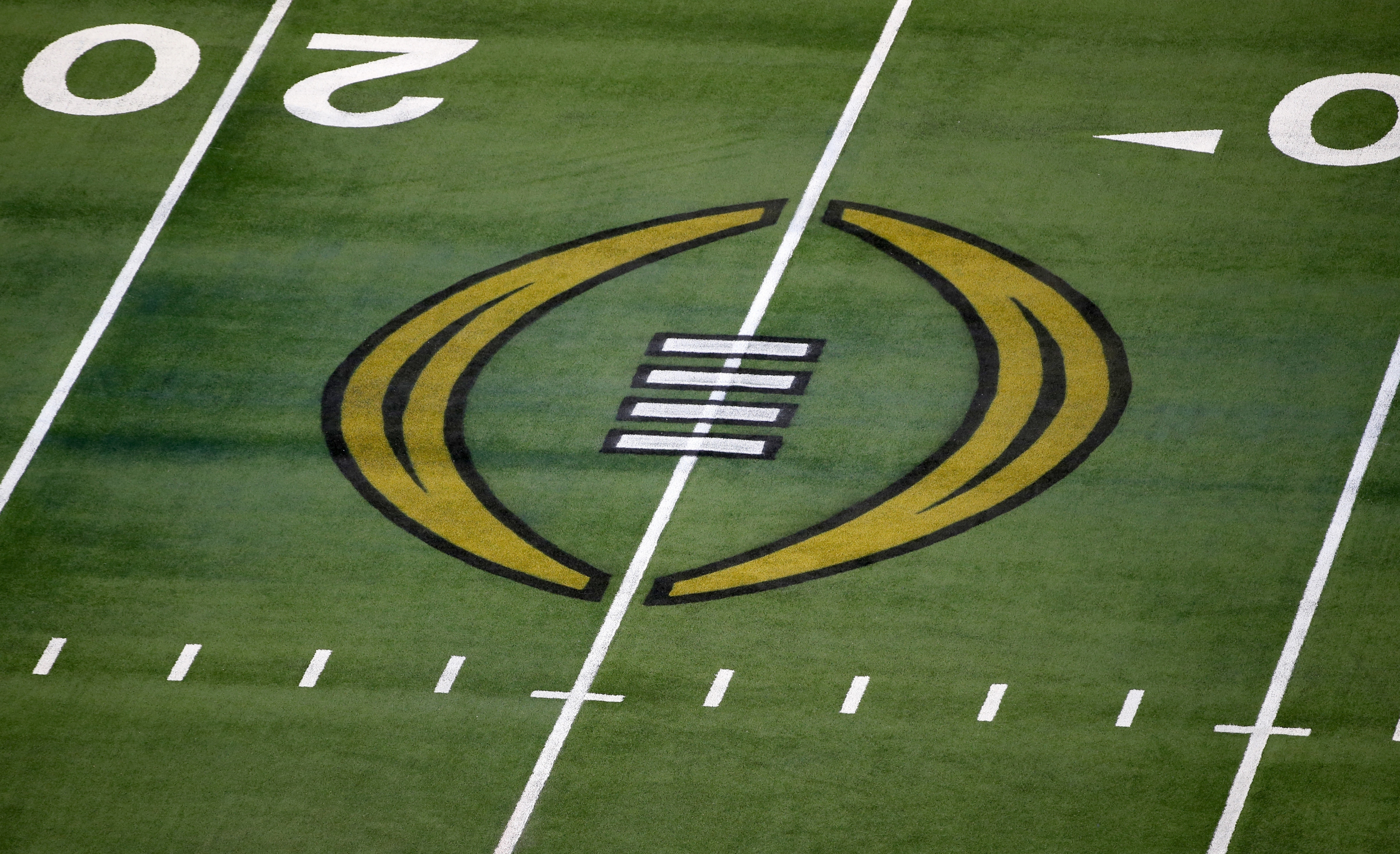The College Football Playoff logo is shown on the field at AT&T Stadium before the Rose Bowl NCAA college football game between Notre Dame and Alabama in Arlington, Texas, Jan. 1, 2021.