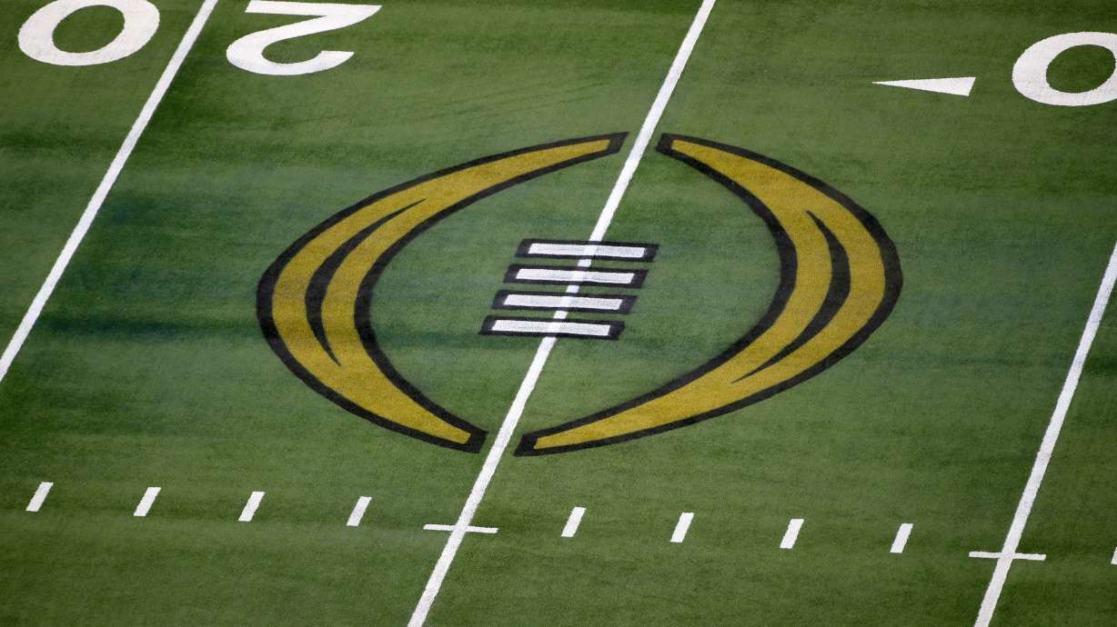 The College Football Playoff logo is shown on the field at AT&T Stadium before the Rose Bowl NCAA college football game between Notre Dame and Alabama in Arlington, Texas, Jan. 1, 2021.
