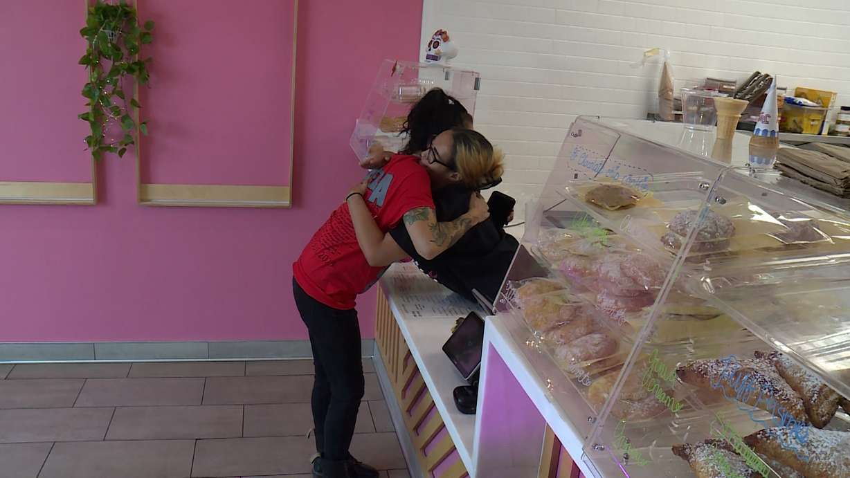 Cecilia "CC" Armenta, right, embraces another at her store on Tuesday. Armenta is in a battle for her health while trying to keep her business open.
