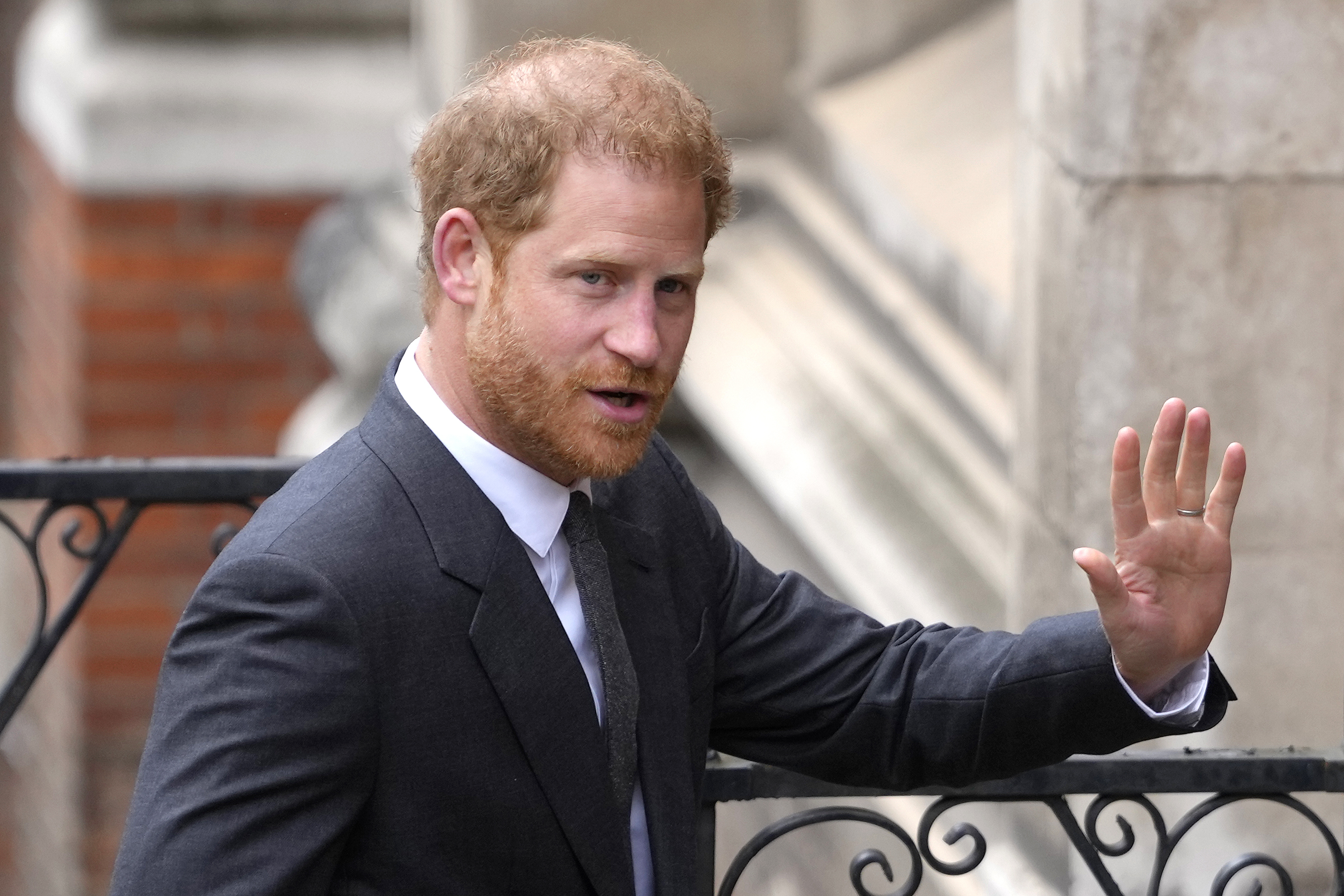 FILE - Britain's Prince Harry salutes media as he arrives at the Royal Courts of Justice in London, on March 30, 2023. Prince Harry is expected to return to the U.K. next month to attend a charity awards ceremony on the eve of the first anniversary of Queen Elizabeth II’s death. 