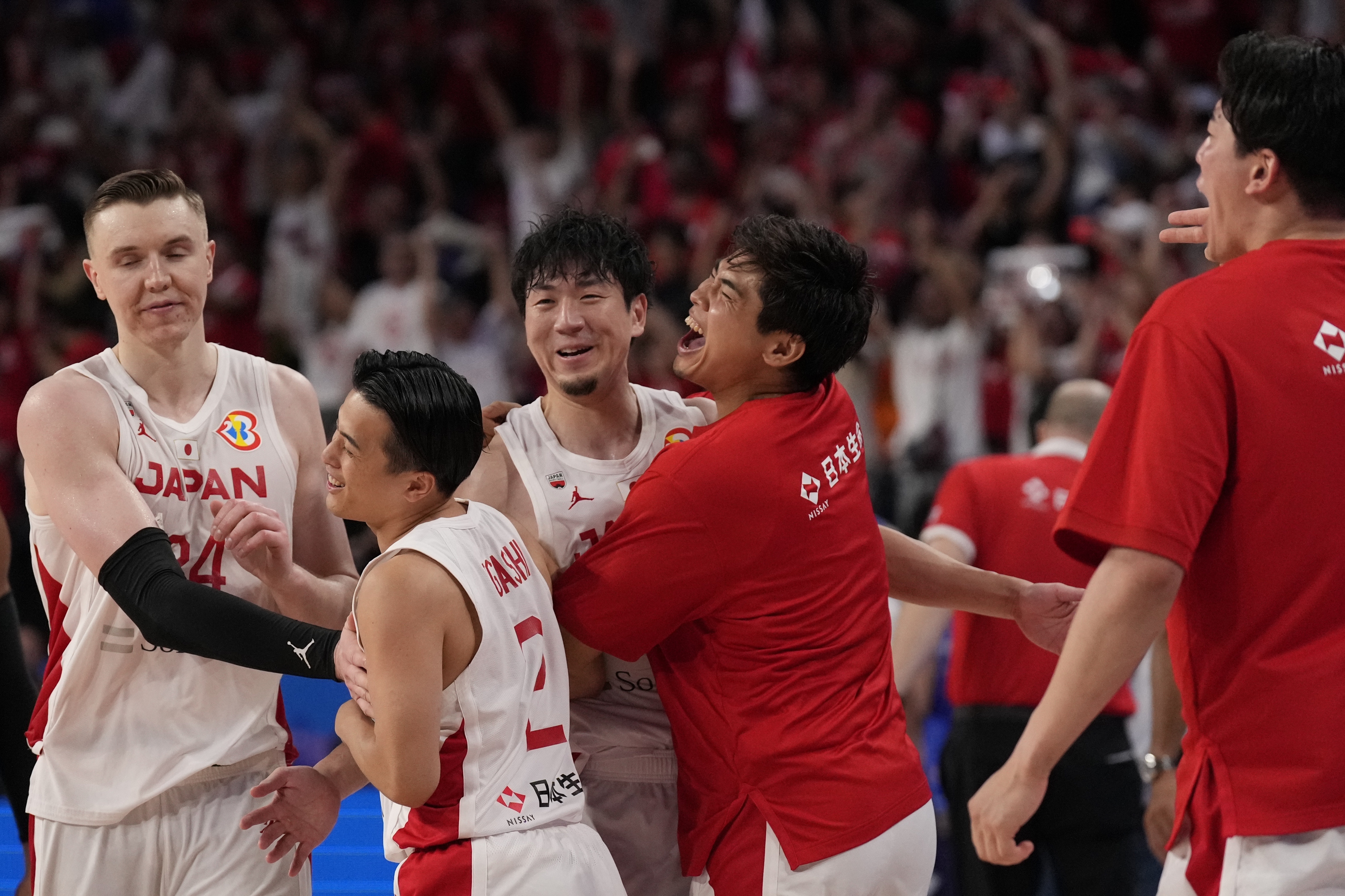 Japan's team members celebrate after defeating Venezuela in their Basketball World Cup classification match in Okinawa, southern Japan, Thursday, Aug. 31, 2023. 