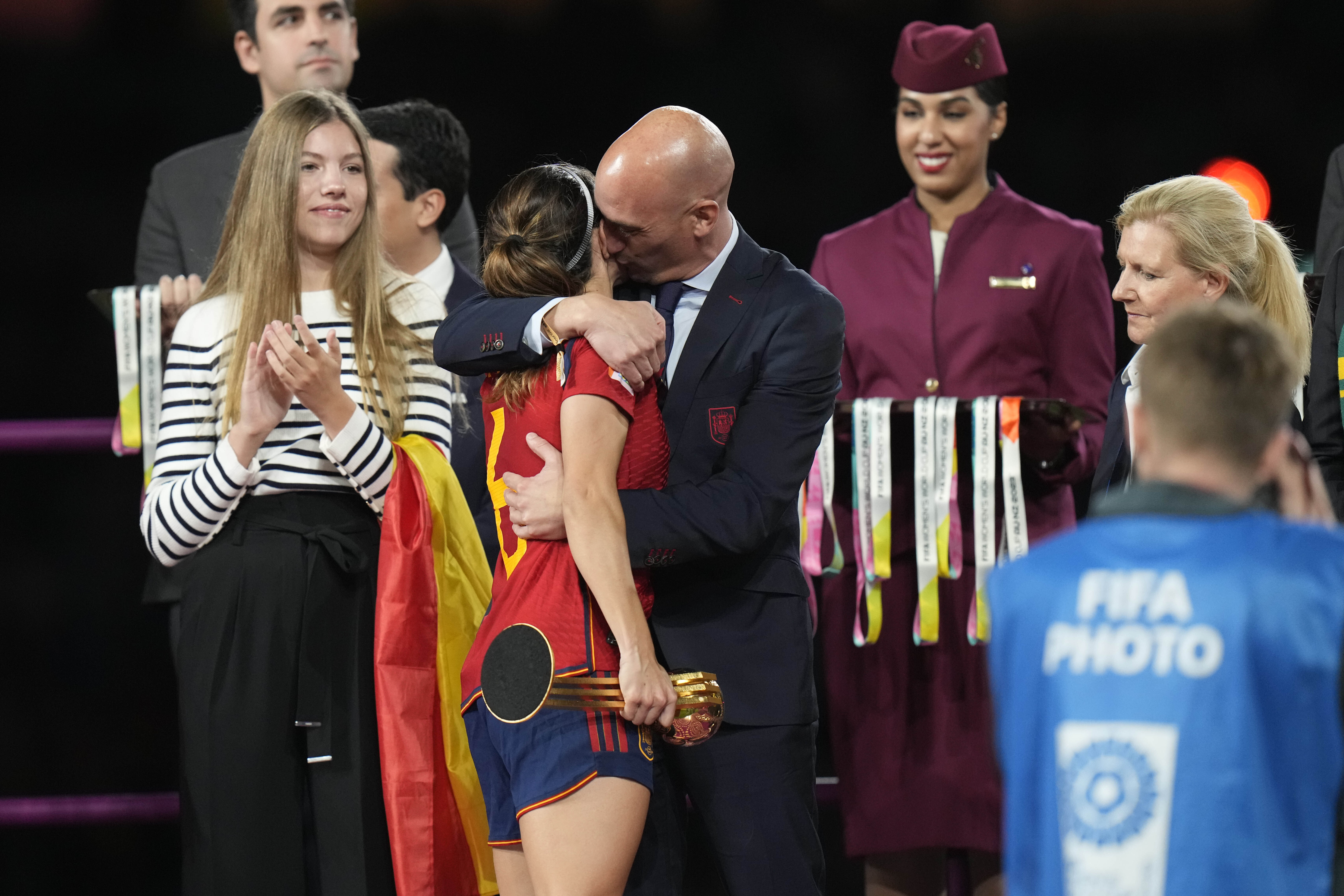 FILE - President of Spain's soccer federation, Luis Rubiales, right, hugs Spain's Aitana Bonmati on the podium following Spain's win in the final of Women's World Cup soccer against England at Stadium Australia in Sydney, Australia, Sunday, Aug. 20, 2023. At left is Spain's Princess Infanta Sofia. 