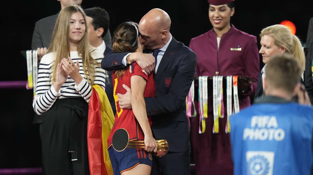 FILE - President of Spain's soccer federation, Luis Rubiales, right, hugs Spain's Aitana Bonmati on the podium following Spain's win in the final of Women's World Cup soccer against England at Stadium Australia in Sydney, Australia, Sunday, Aug. 20, 2023. At left is Spain's Princess Infanta Sofia.