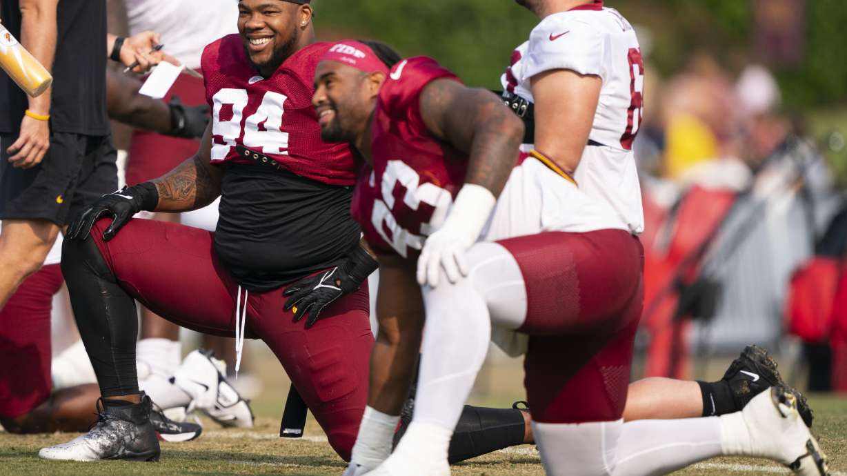Washington Commanders defensive tackle Daron Payne, left, and defensive tackle Jonathan Allen warm up during an NFL football practice at the team's training facility, Wednesday, Aug. 2, 2023, in Ashburn, Va.