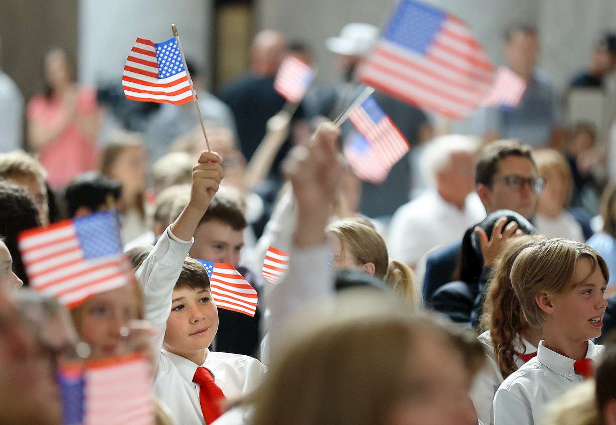 Bennett Anderson waves an American flag during the Constitution Month kickoff event at the Capitol in Salt Lake City on Thursday.