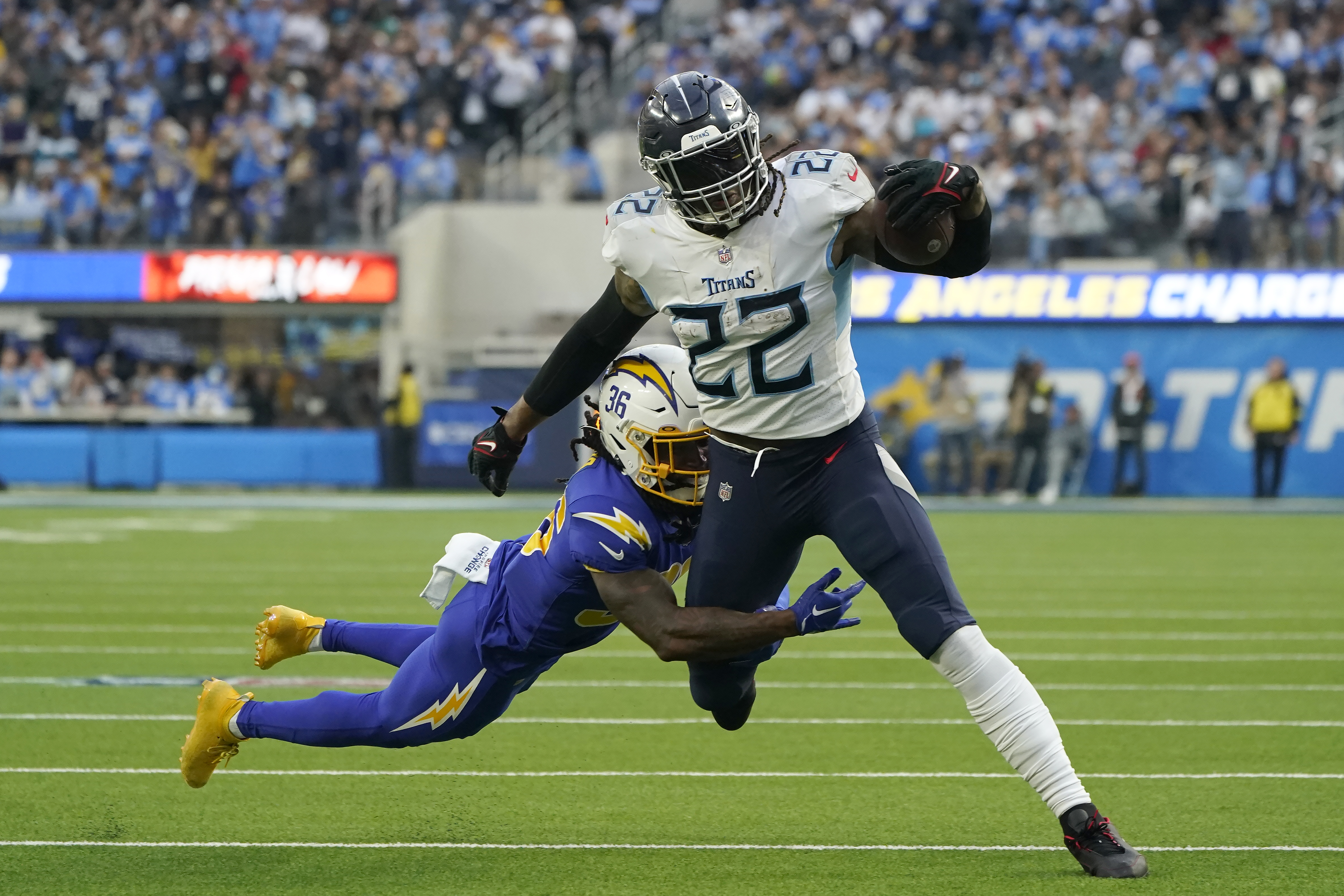 FILE - Tennessee Titans running back Derrick Henry (22) runs against Los Angeles Chargers cornerback Ja'Sir Taylor (36) during the first half of an NFL football game in Inglewood, Calif., Sunday, Dec. 18, 2022. Henry is perhaps the best dominant runner in the game with more than 1,500 yards on the ground in three of the past four seasons. 