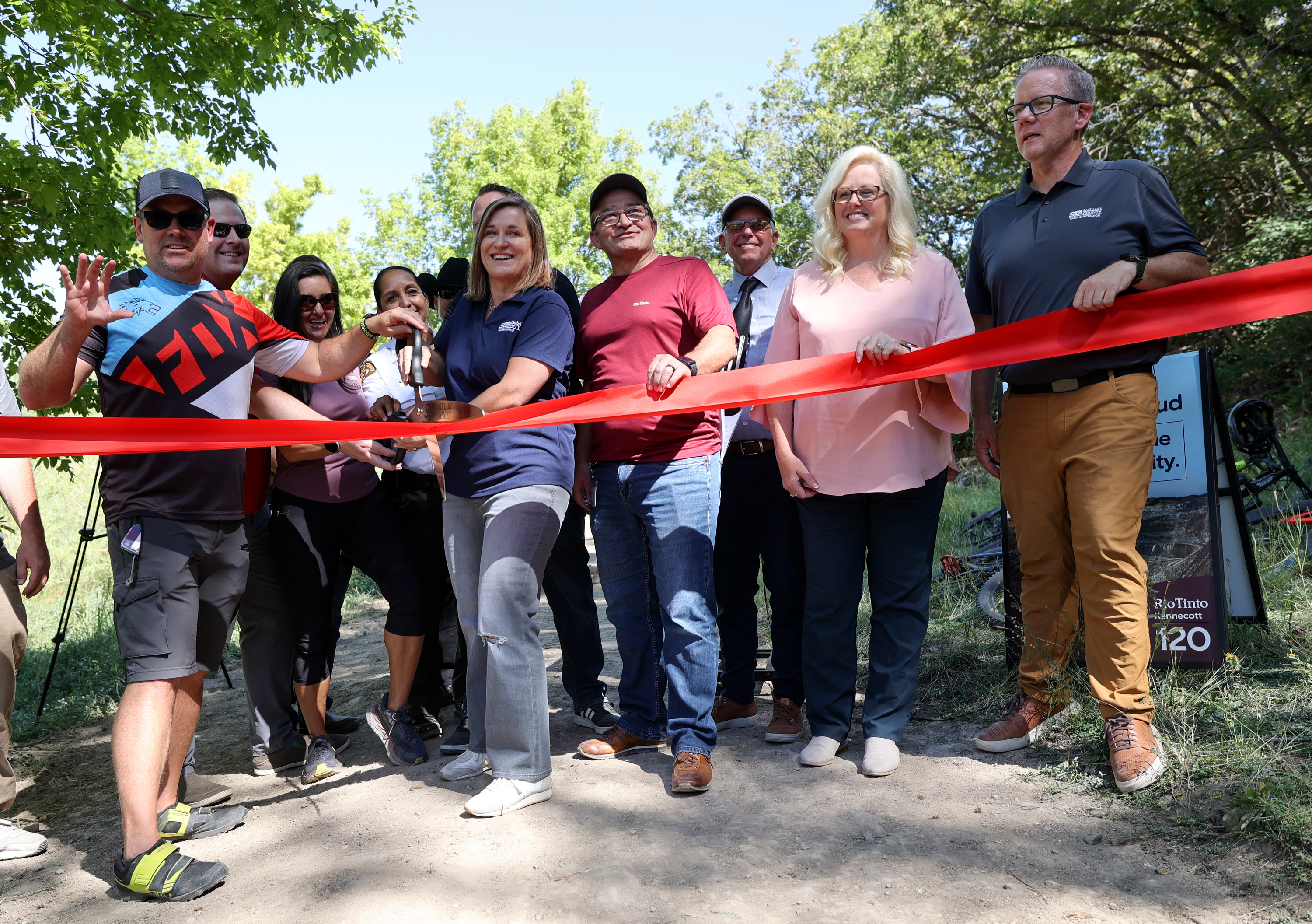 Salt Lake County Mayor Jenny Wilson holds the ceremonial scissors during the ribbon-cutting ceremony for Butterfield Trailhead Regional Park, which will offer 14 miles of trails for hikers, mountain bikers and equestrians near Herriman in Utah County on Thursday.