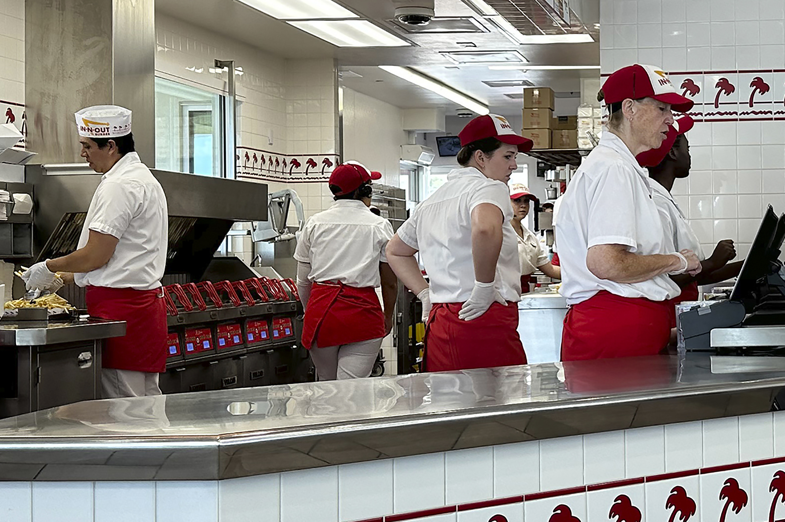 Workers prepare food and take orders an In-N-Out burger restaurant Aug. 8, in Thornton, Colo. The nation's employers added a solid 187,000 jobs in August, the U.S. government reported Friday.