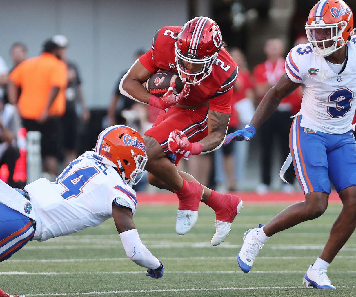 Utah Utes running back Micah Bernard (2) runs against Florida Gators safety Jordan Castell (14) in Salt Lake City on Thursday, Aug. 31, 2023 during the season opener.