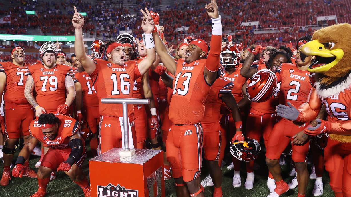 Utah Utes quarterback Bryson Barnes (16) and Utah Utes quarterback Nate Johnson (13) celebrate the Ute win over the Florida Gators in Salt Lake City on Thursday, Aug. 31, 2023 during the season opener. Utah won 24-11.