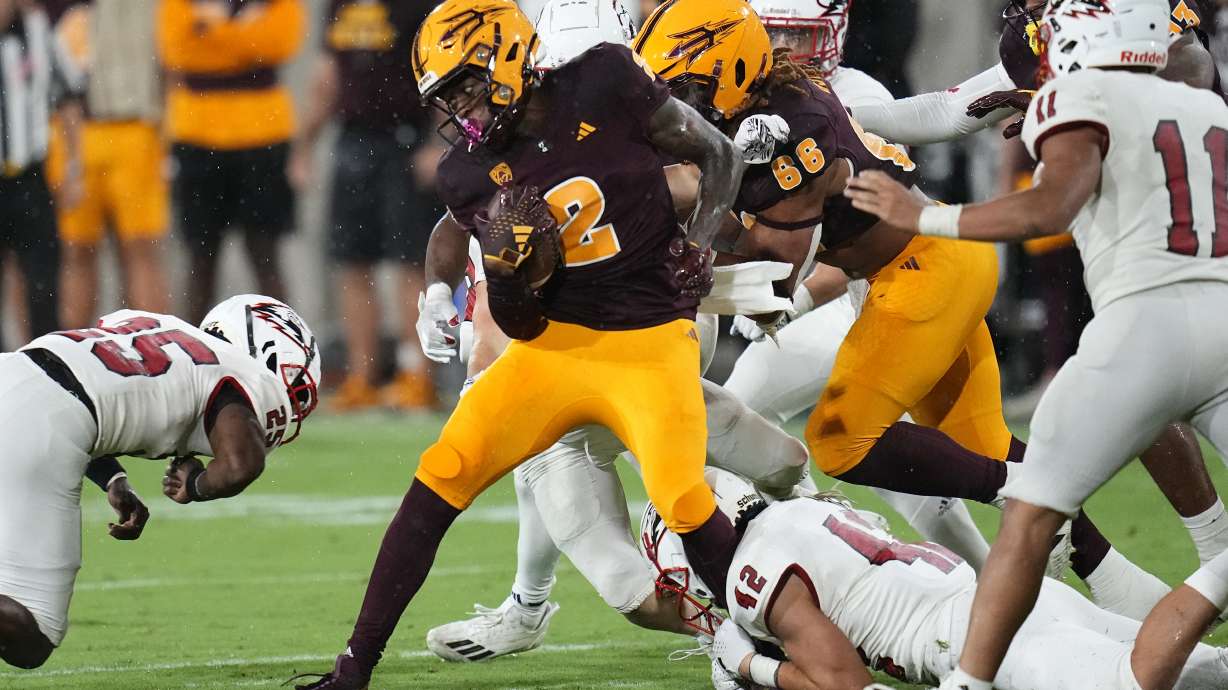 Arizona State kick returner Elijhah Badger (2) returns a kick as Southern Utah running back Cade Bowring (42) makes the tackle as Southern Utah cornerback Quadir Lockett-Smith, left, and Southern Utah safety George Ramirez (11) arrive to help during the second half of an NCAA college football game Friday, Sept. 1, 2023, in Tempe, Ariz. Arizona State won 24-21.