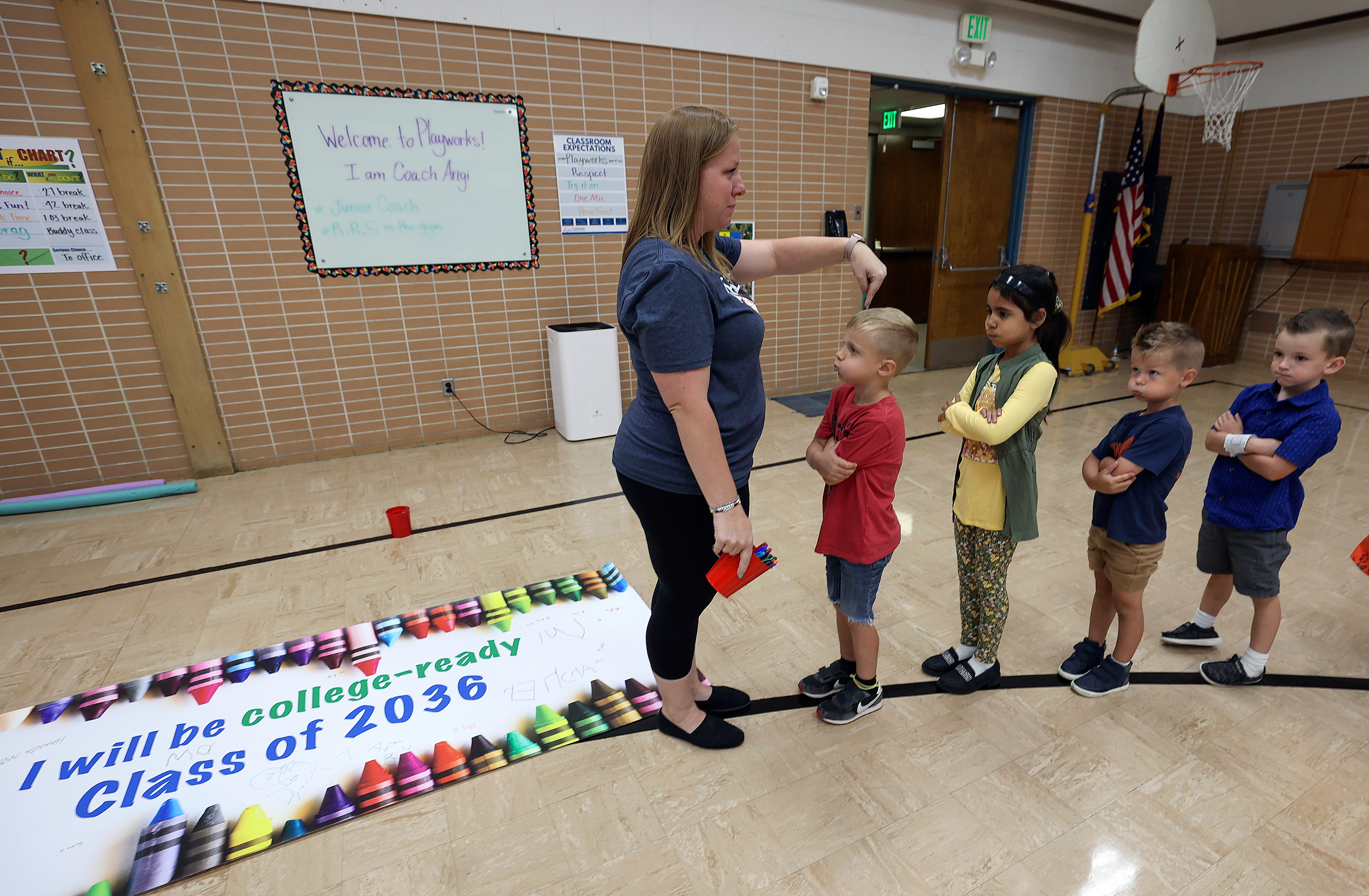Kindergarten teacher Amy Dinkelman lines up her class after they signed an “I will be college-ready Class of 2036” poster during Kindergarten College-Ready Day at Ridgecrest Elementary School in Cottonwood Heights on Friday. Kindergartners, from left, are Archer Juhlin, Haania Mirza, Maverick Hill and Charlie Peterson.