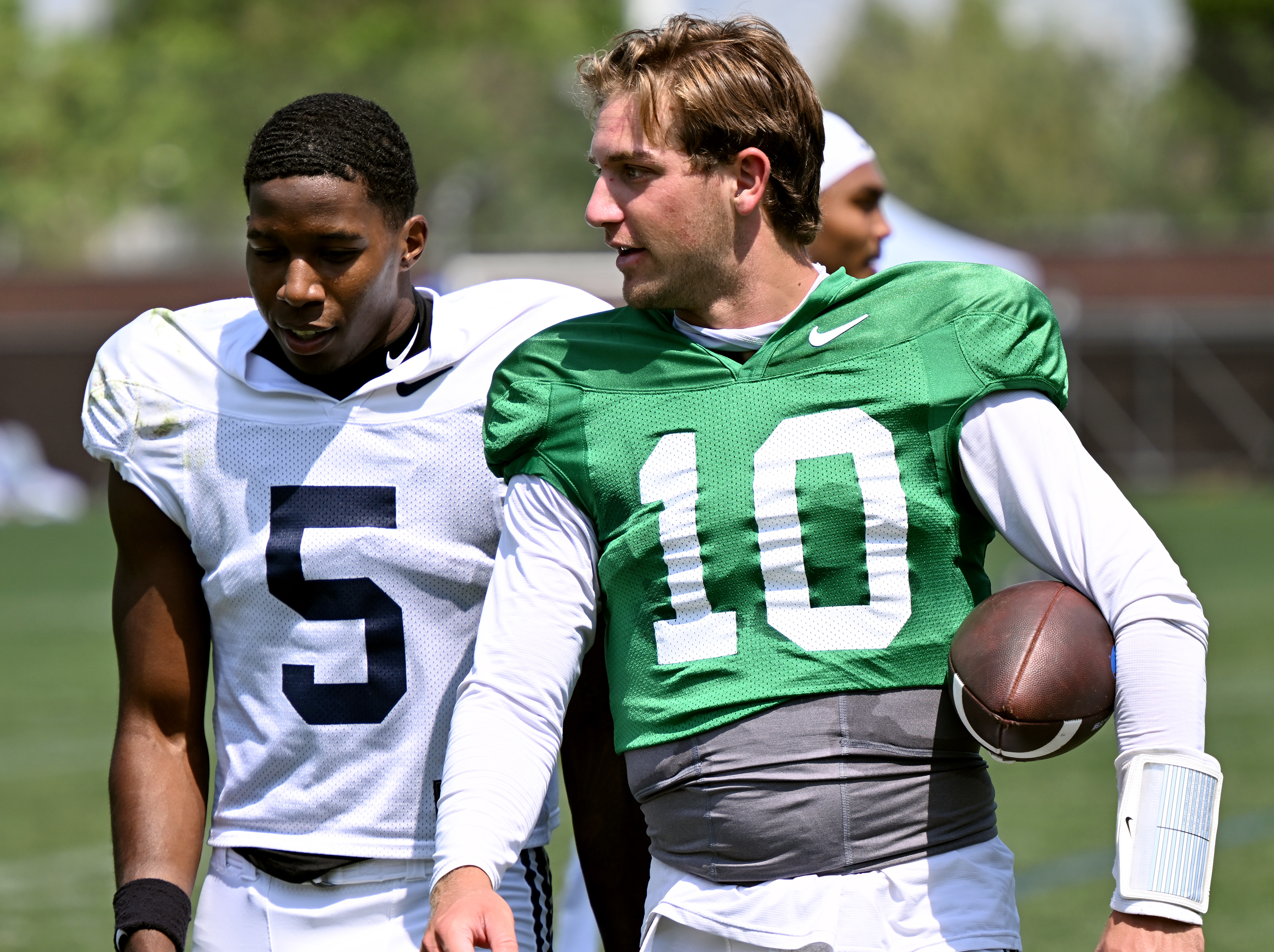 Wide receiver Darius Lassiter and quarterback Kedon Slovis talk as they walk off the practice field after BYU’s practice in Provo on Tuesday, Aug. 8, 2023.