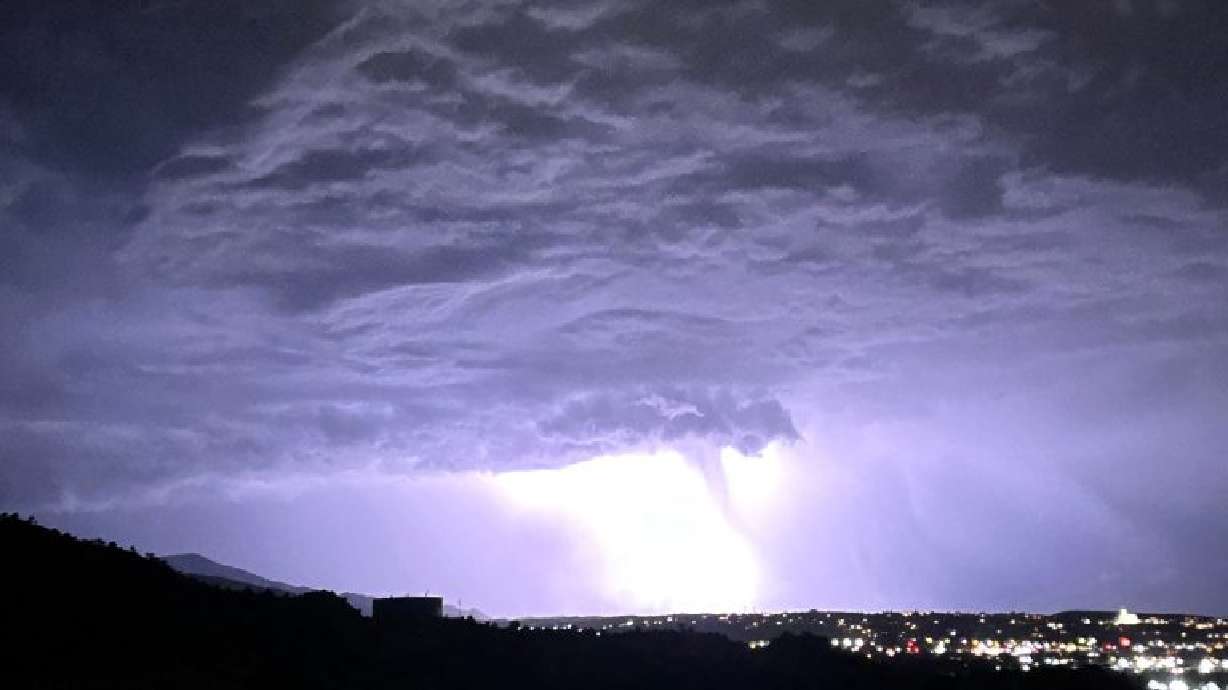 National Weather Service said light from lightning made a shaft of rain look like a funnel cloud over Cedar City, Utah, Thursday.