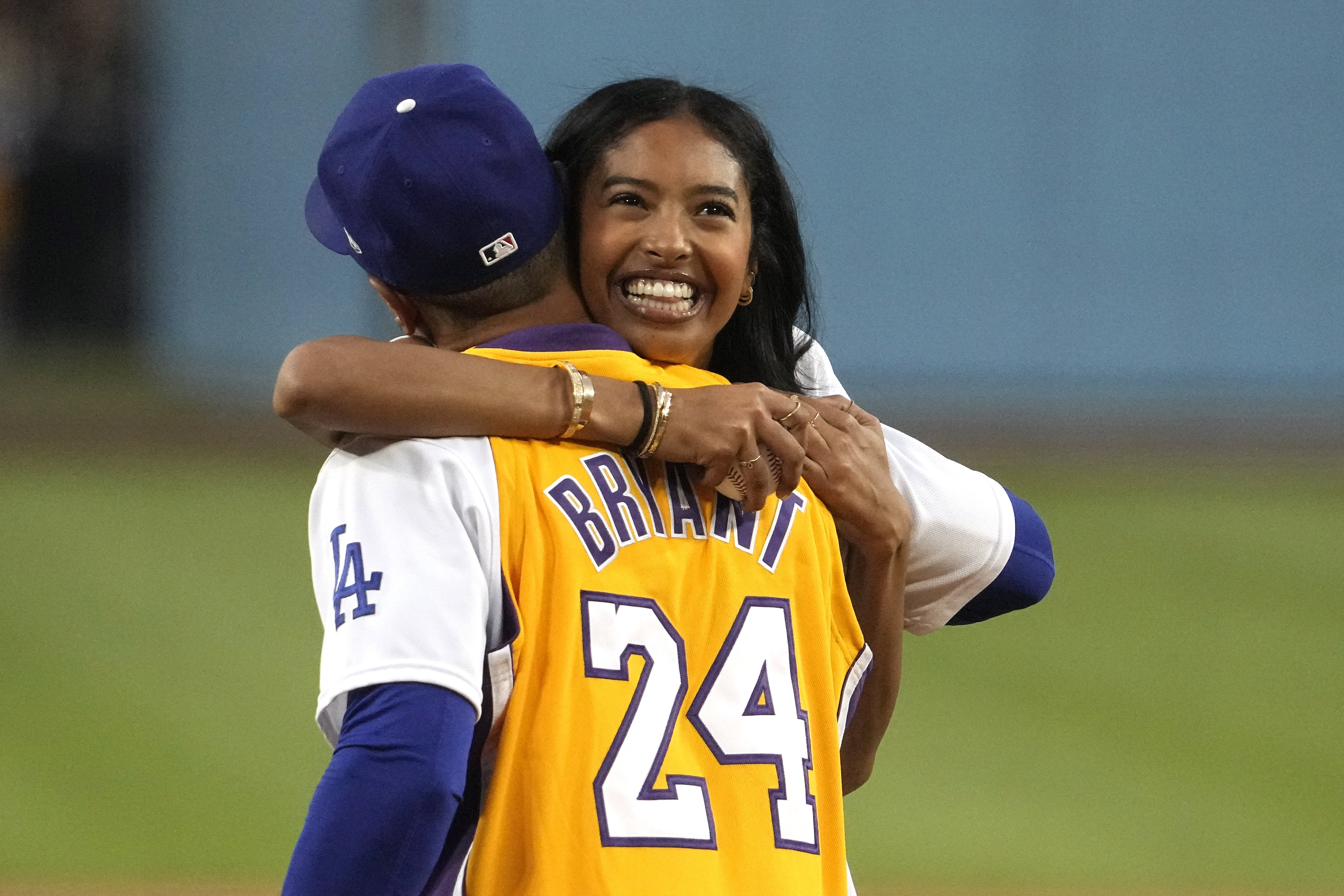 Natalia Bryant, daughter of Kobe Bryant, hugs Los Angeles Dodgers' Mookie Betts after throwing out the ceremonial first pitch prior to a baseball game between the Dodgers and the Atlanta Braves Friday, Sept. 1, 2023, in Los Angeles. 